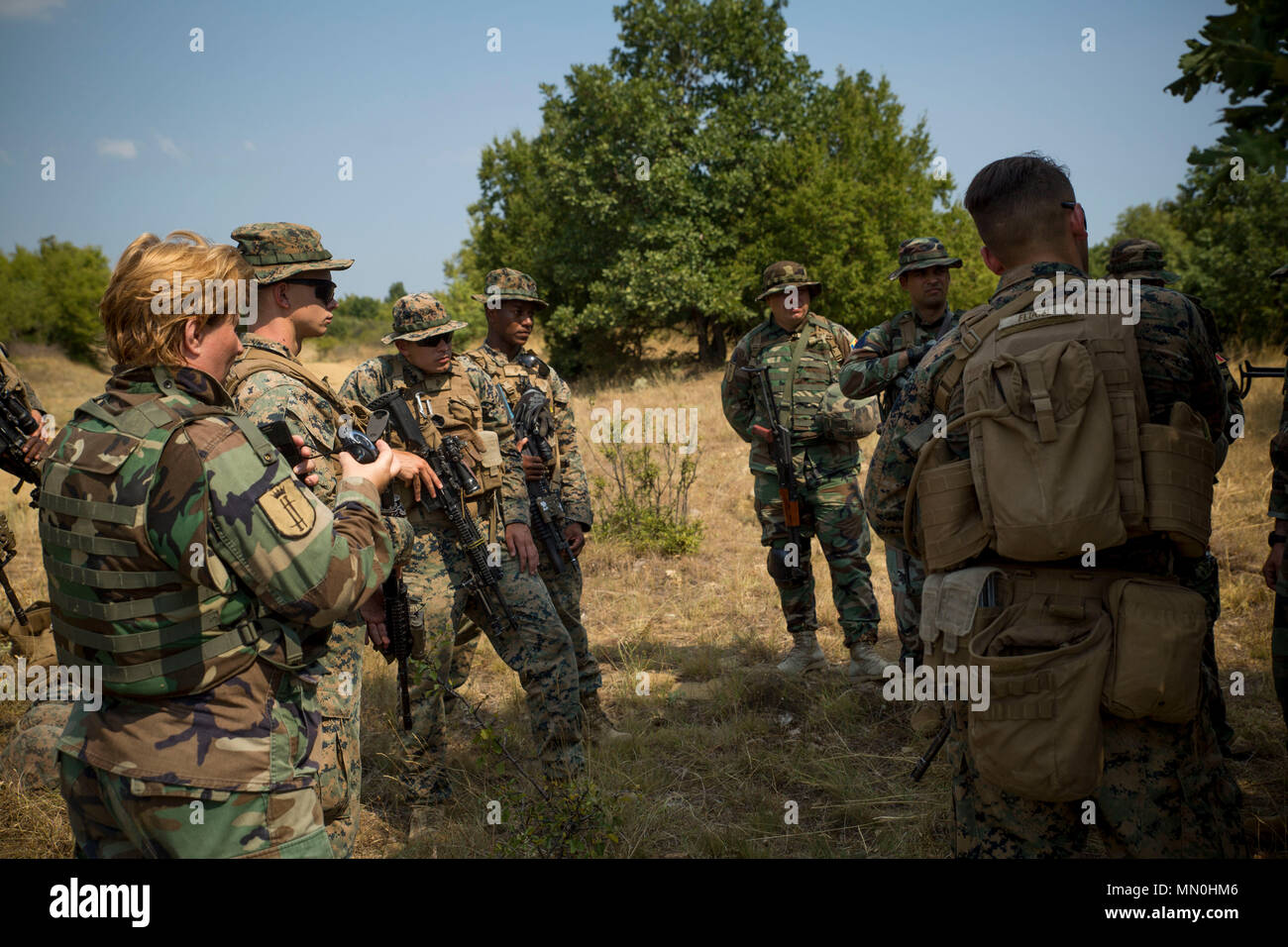 U.S. Marines with Black Sea Rotational Force 17.1 exchange patrolling tactics with Moldovan soldiers during a patrolling field exercise aboard Novo Selo Training Area, Bulgaria, Aug. 6, 2017. The event was part of Exercise Platinum Lion 17.2, an exercise designed to build interoperability between NATO Allies and partner nations. (U.S. Marine Corps photo by Cpl. Victoria Ross) Stock Photo