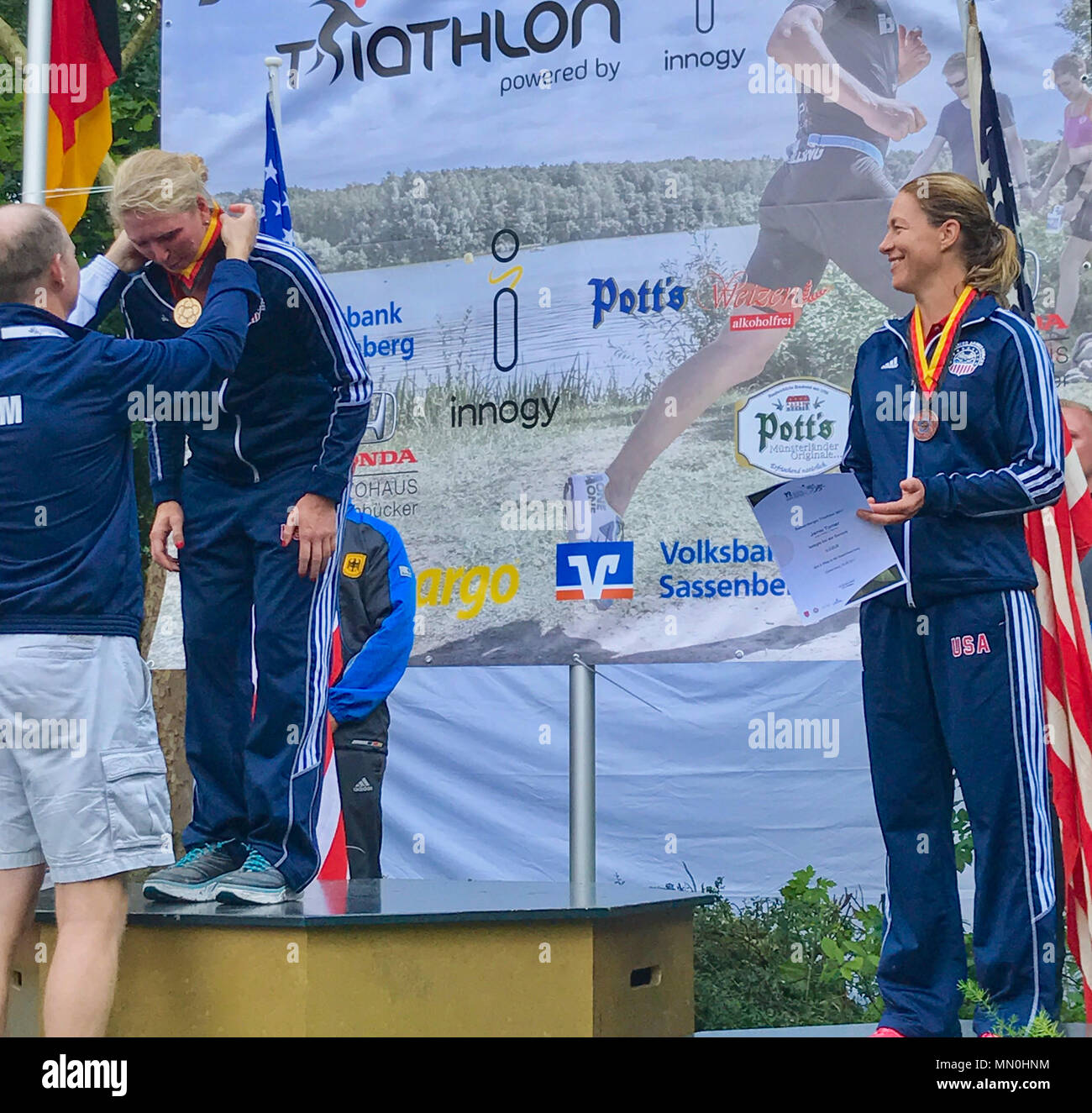 Air Force Maj. Judy Coyle is awarded the Gold Medal in the Women’s Master’s Division of the World Military Triathlon in Sassenberg, Germany Aug.t 5, 2017. The World Military Triathlon Championship is hosted by the International Military Sports Council, whose mission is to build friendship through sports. (U.S. Marine Corps photo by Lance Cpl. Troy Saunders/Released) Stock Photo