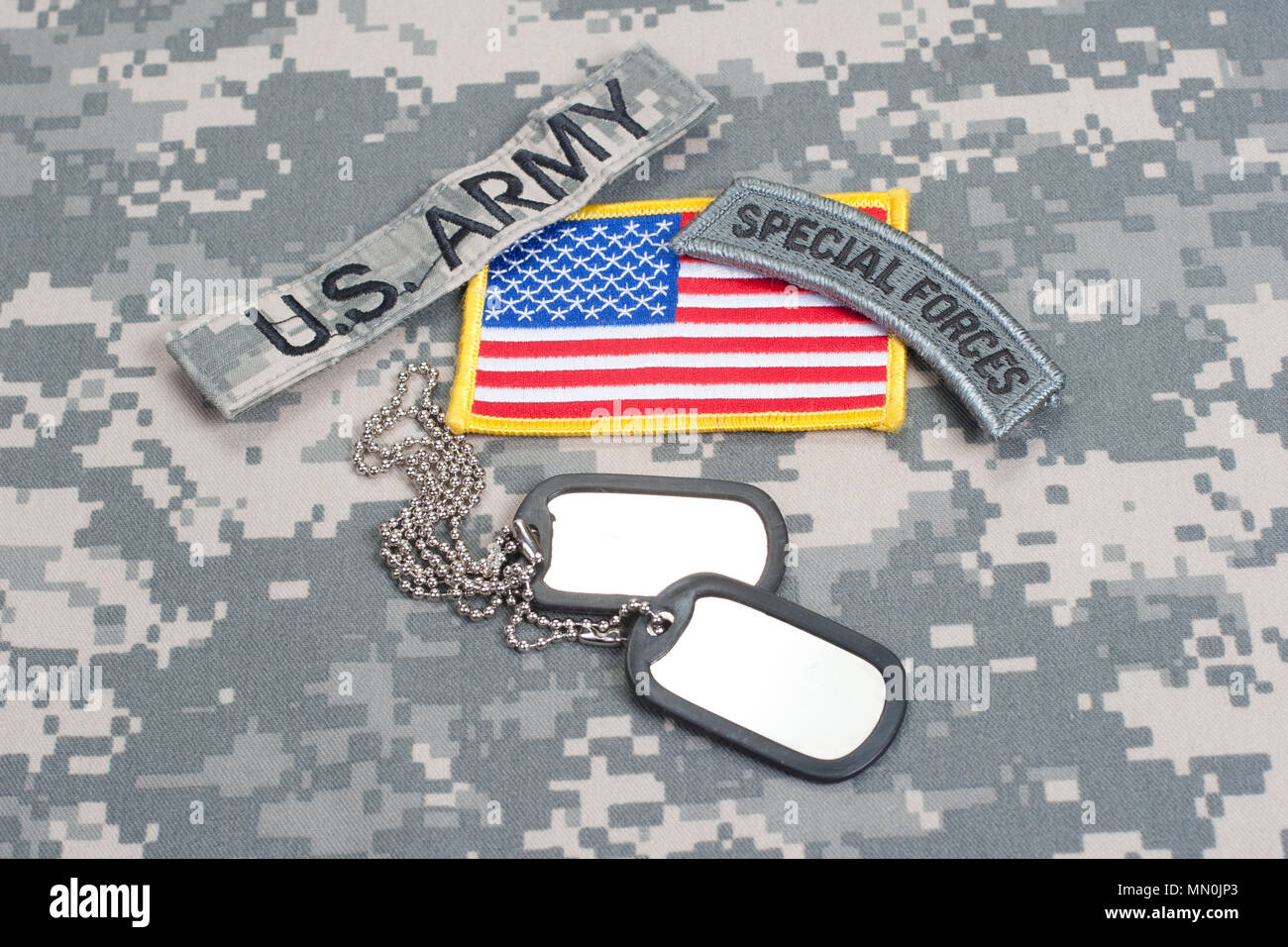 US ARMY special forces tab with blank dog tags on camouflage uniform ...