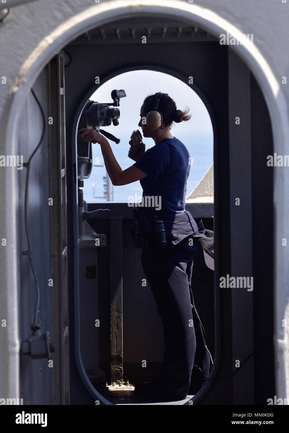 ARABIAN GULF (Aug. 6, 2017) U.S. Navy Seaman Sydney Wells from Barnesville, Ohio, speaks into a sound powered telephone aboard the aircraft carrier USS Nimitz (CVN 68), Aug. 6, 2017, in the Arabian Gulf. Nimitz is deployed in the U.S. 5th Fleet area of operations in support of Operation Inherent Resolve. While in this region, the ship and strike group are conducting maritime security operations to reassure allies and partners, preserve freedom of navigation, and maintain the free flow of commerce. (U.S. Navy photo by Mass Communication Specialist Seaman Kennishah J. Maddux) Stock Photo