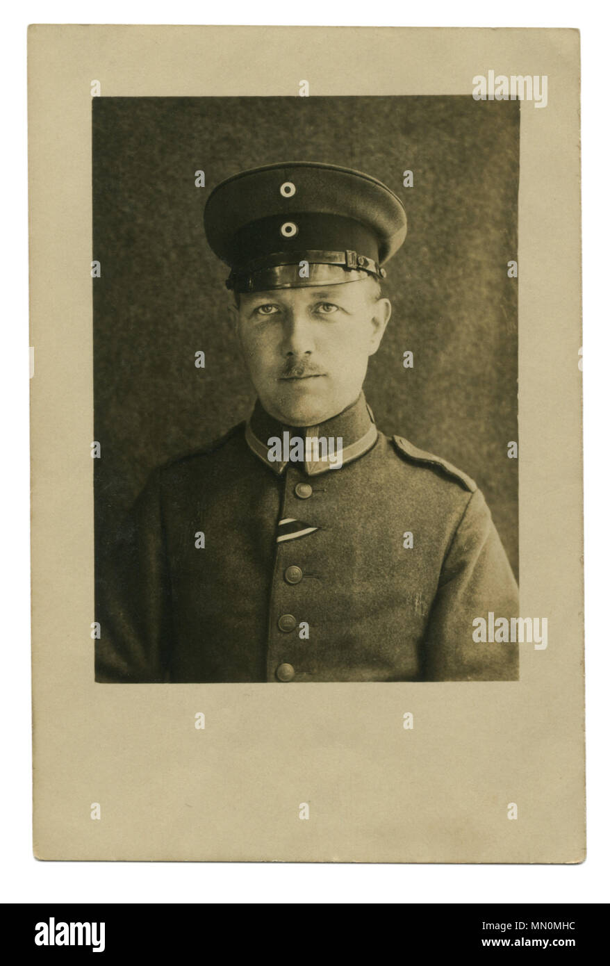 Old German photo of 1917: Soldier in uniform, with black and white ribbon on the chest: the award of the second class iron cross. world war I 1914-18 Stock Photo