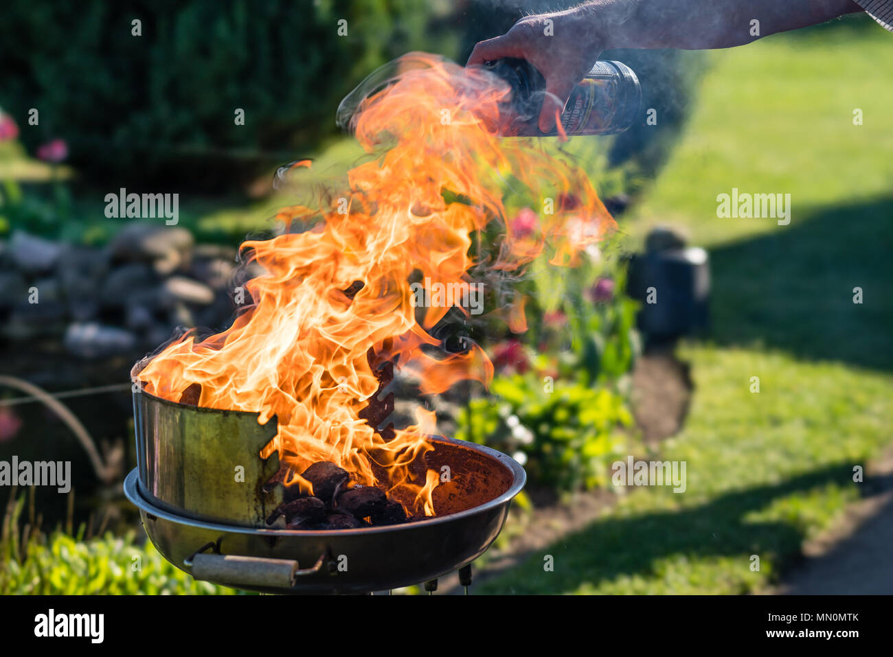 Liquid grill lighter on a charcoal grill Stock Photo