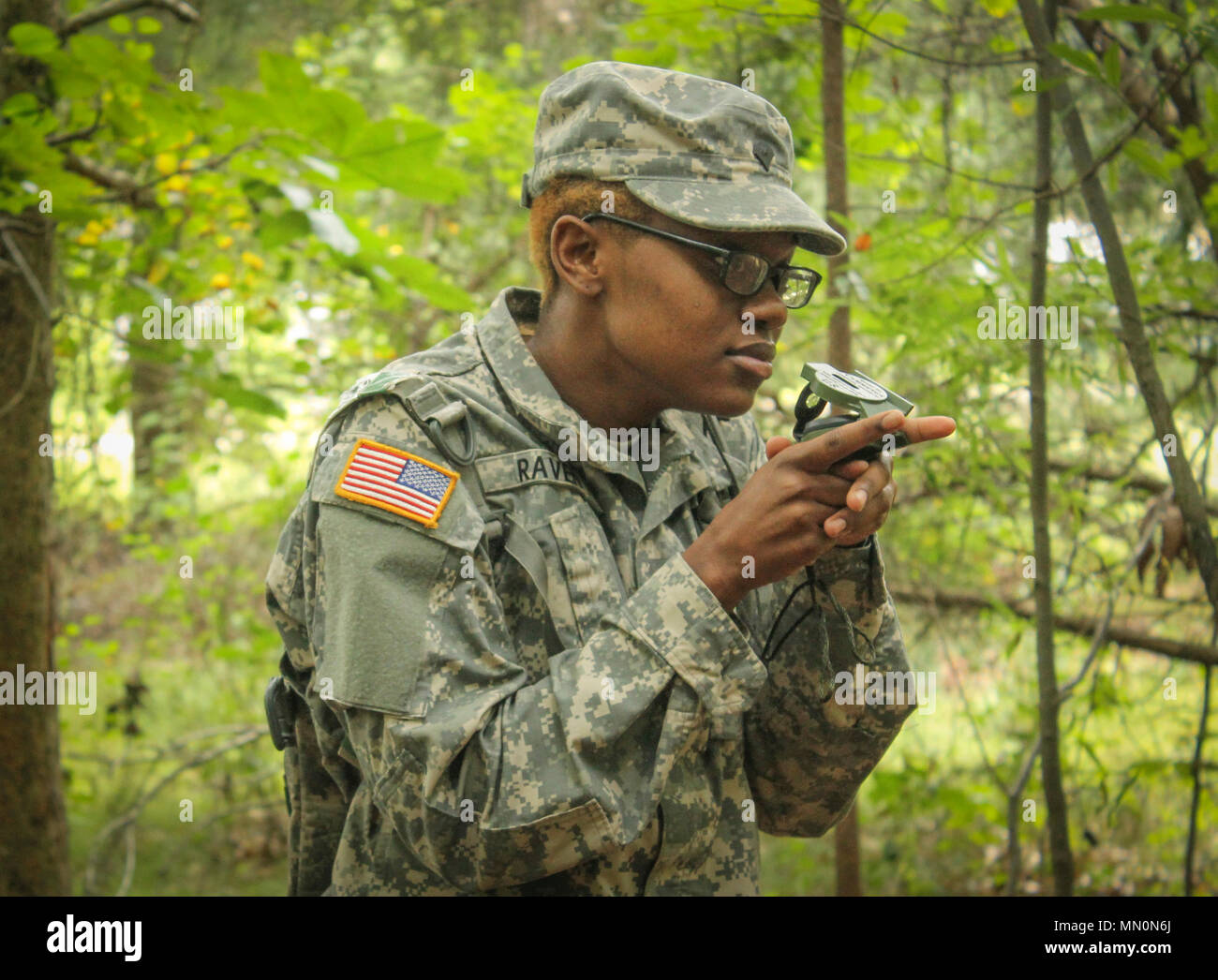 Army Reserve Soldier Spc. Zana Raven, human resource specialist, 335th  Signal Command (Theater) uses her compass to shoot an azimuth in order to  navigate through a land navigation exercise on Joint Base