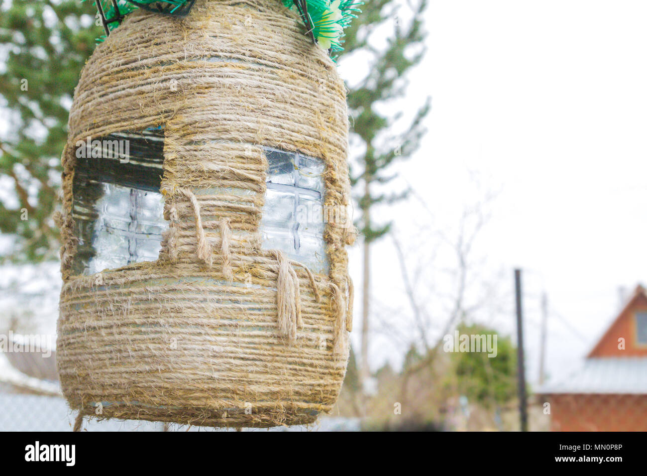 Homemade birdhouse made of plastic bottle and rope Stock Photo - Alamy, image size:1300x956