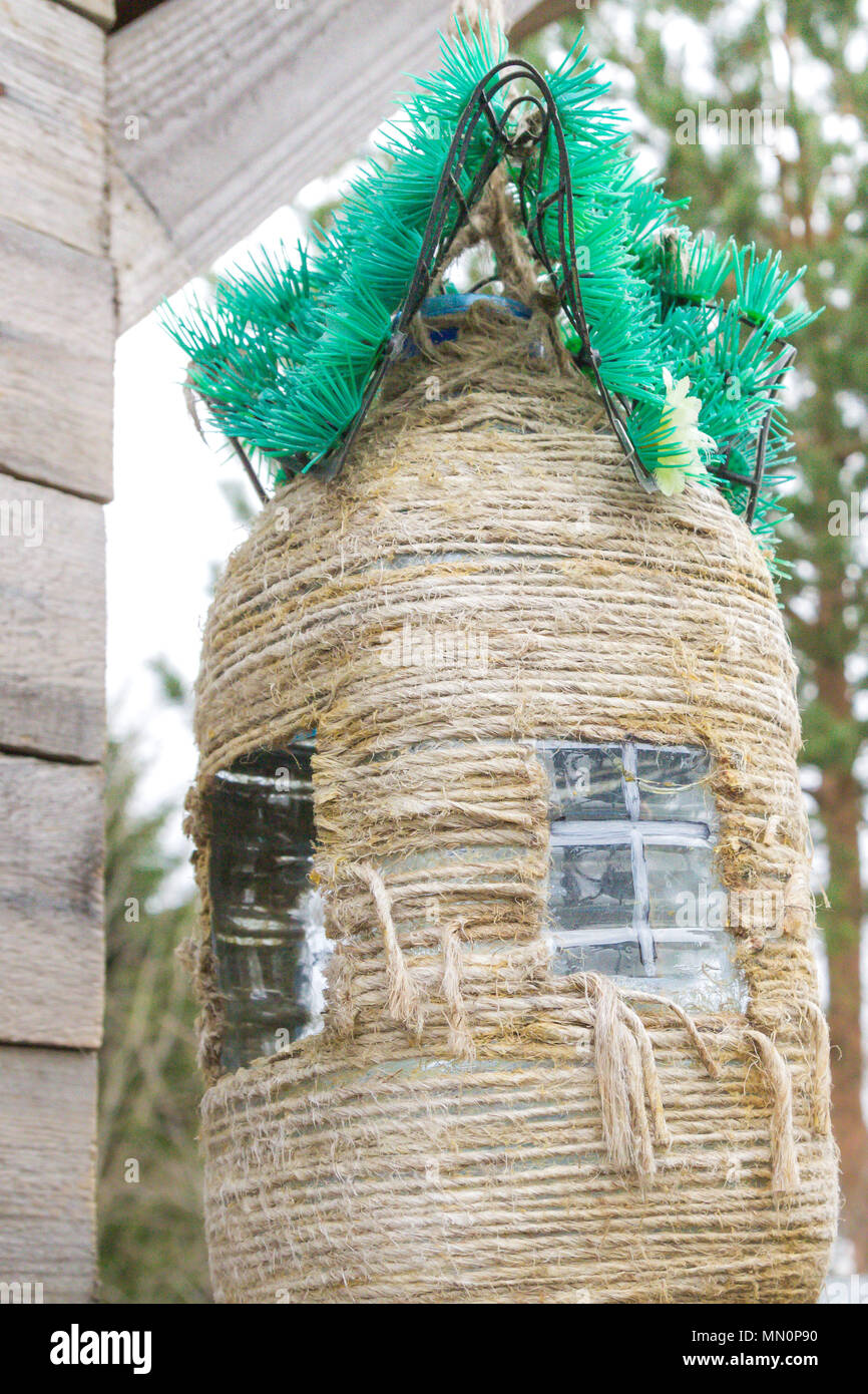 Homemade birdhouse made of plastic bottle and rope Stock Photo