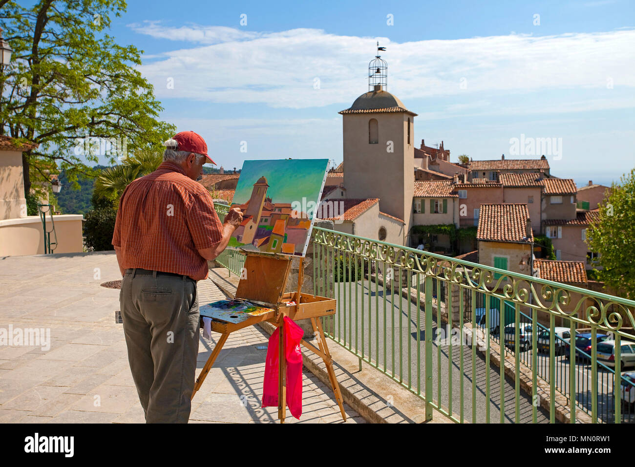 Landscape painter at work, view on Ramatuelle and the church Notre-Dame, Cote d'Azur, Département Var, Provence-Alpes-Côte d’Azur, France Stock Photo