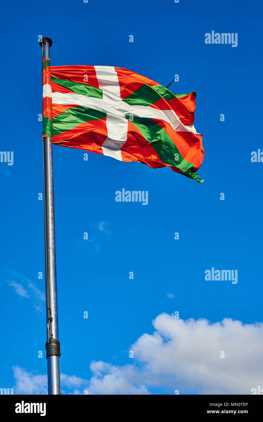 Ikurrina, Basque Country flag waving on a blue sky. Spain. Stock Photo