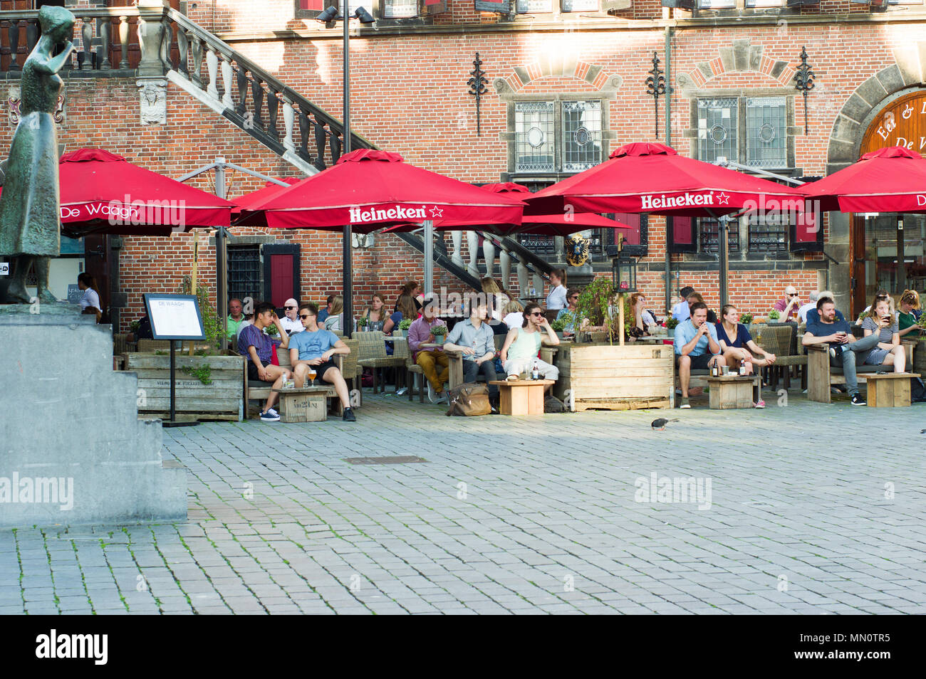 People relax and enjoy a drink at an outdoor cafe terrace Stock Photo ...