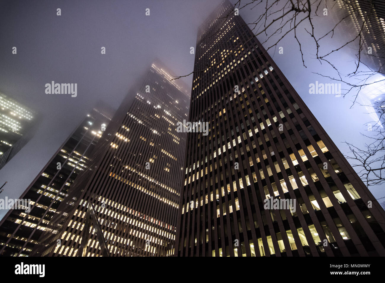 New York, US - March 30, 2018:  Skyscrapers obscured by heavy fog at night in New York city Stock Photo
