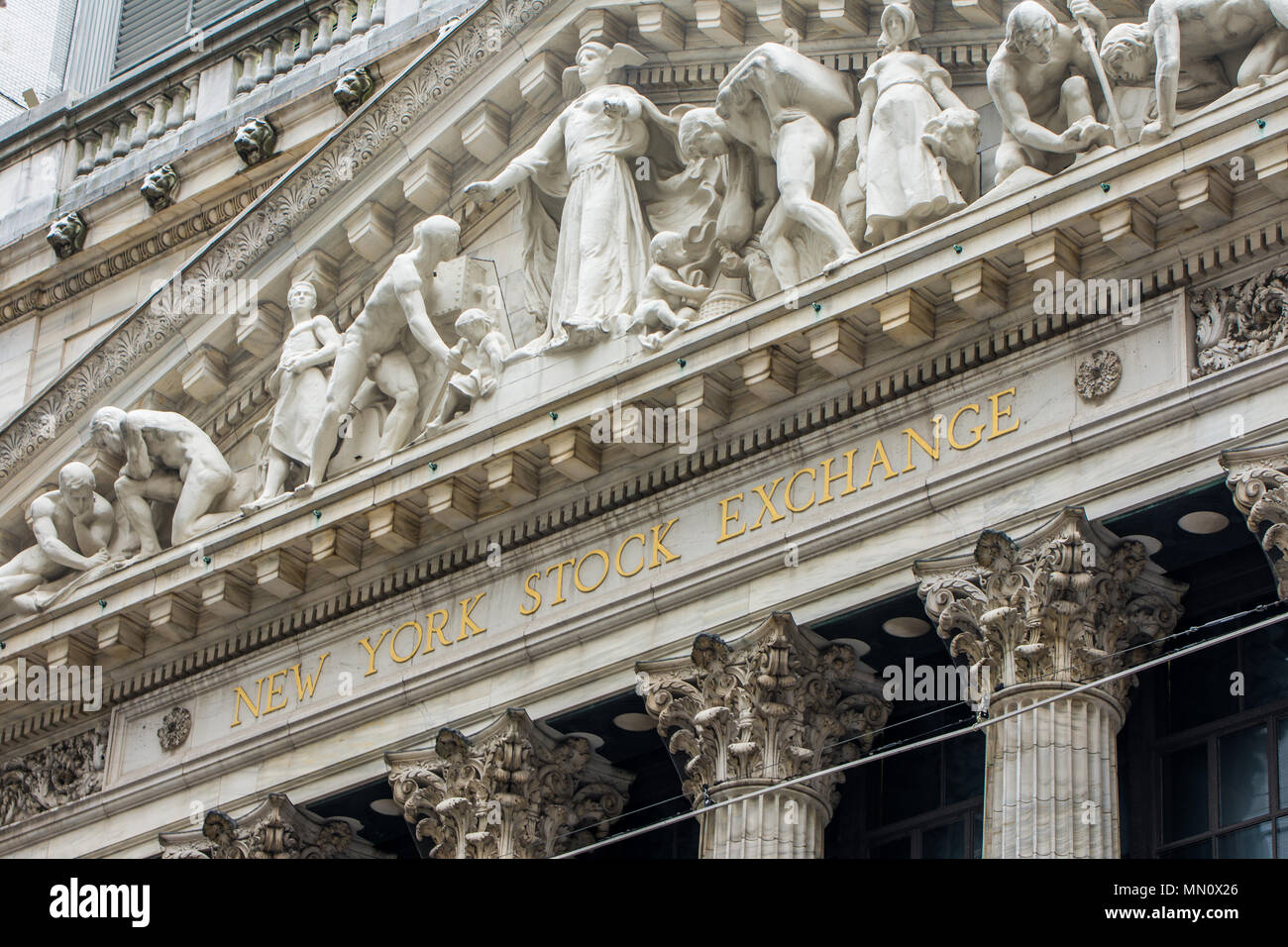 New York, US - March 29, 2018:  The front facade and sign of the New York Stock Exchange at wall street Stock Photo