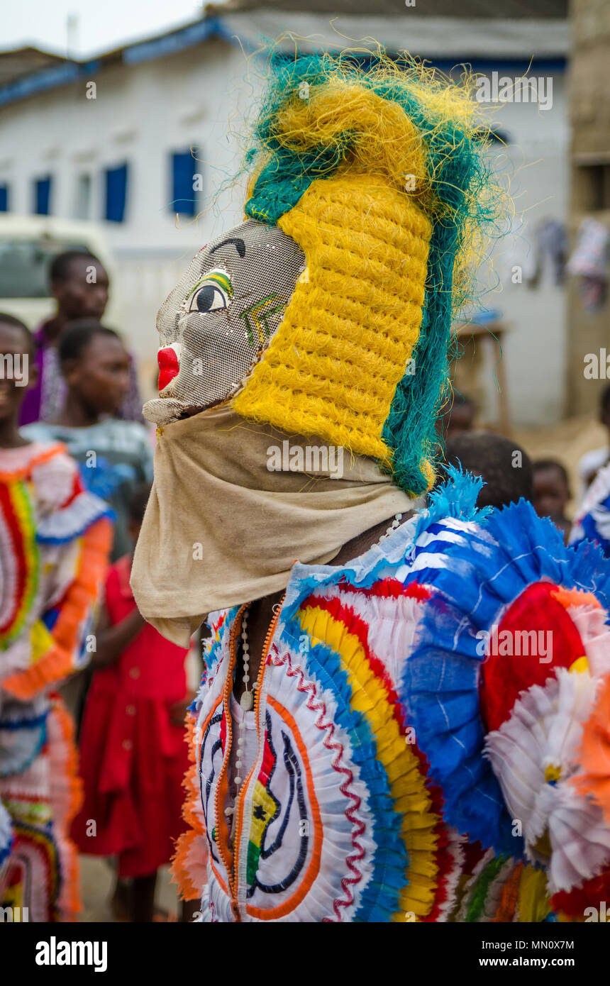Cape Coast, Ghana - February 15, 2014: Colorful masked and costumed dancer during African carnival festivities Stock Photo