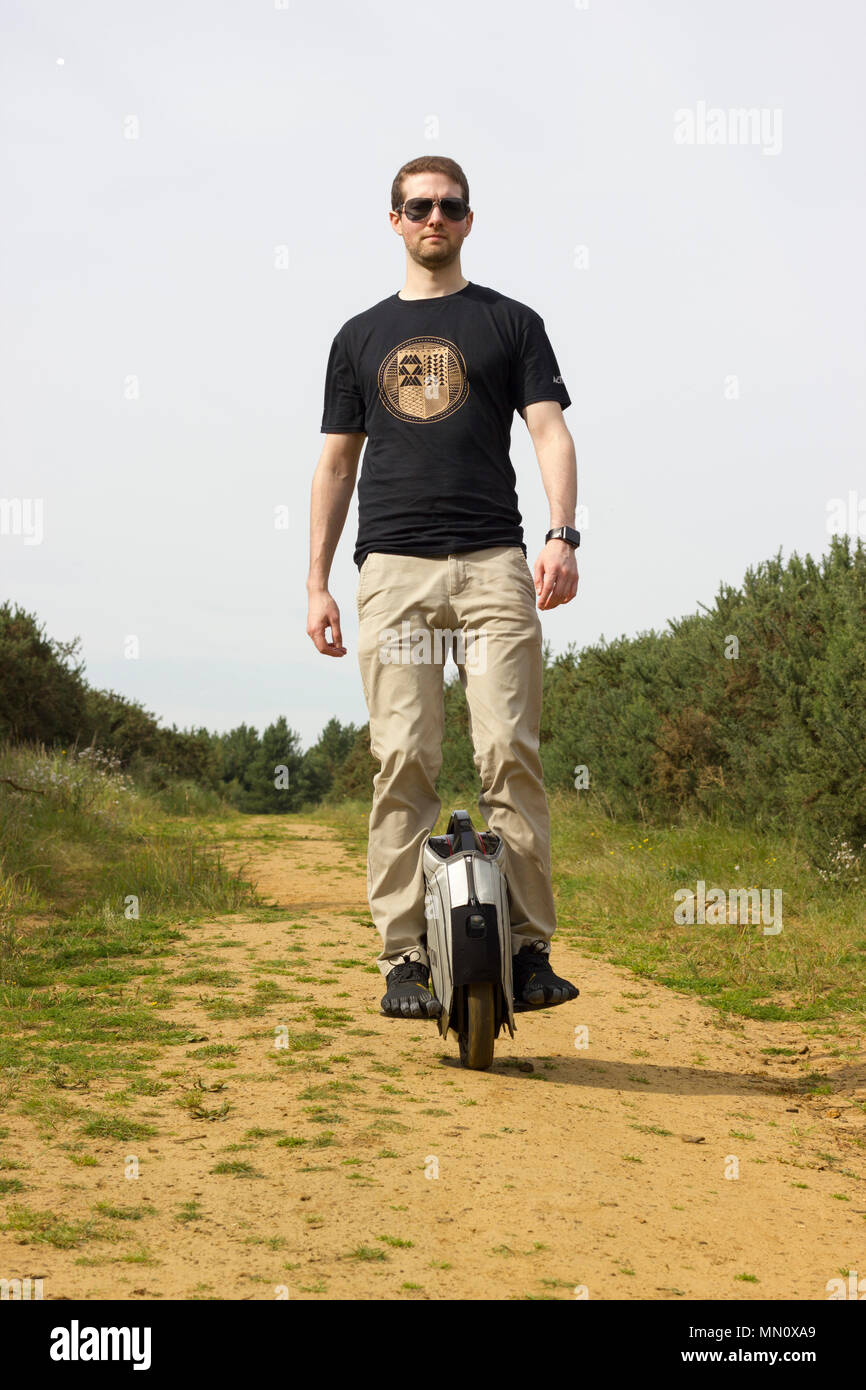 Man riding on a Electric Unicycle. Stock Photo