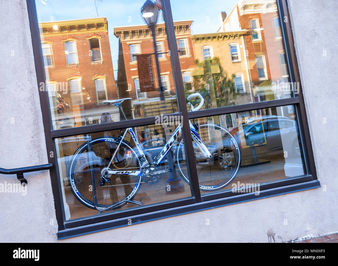 Bicycle in store window with reflections Stock Photo