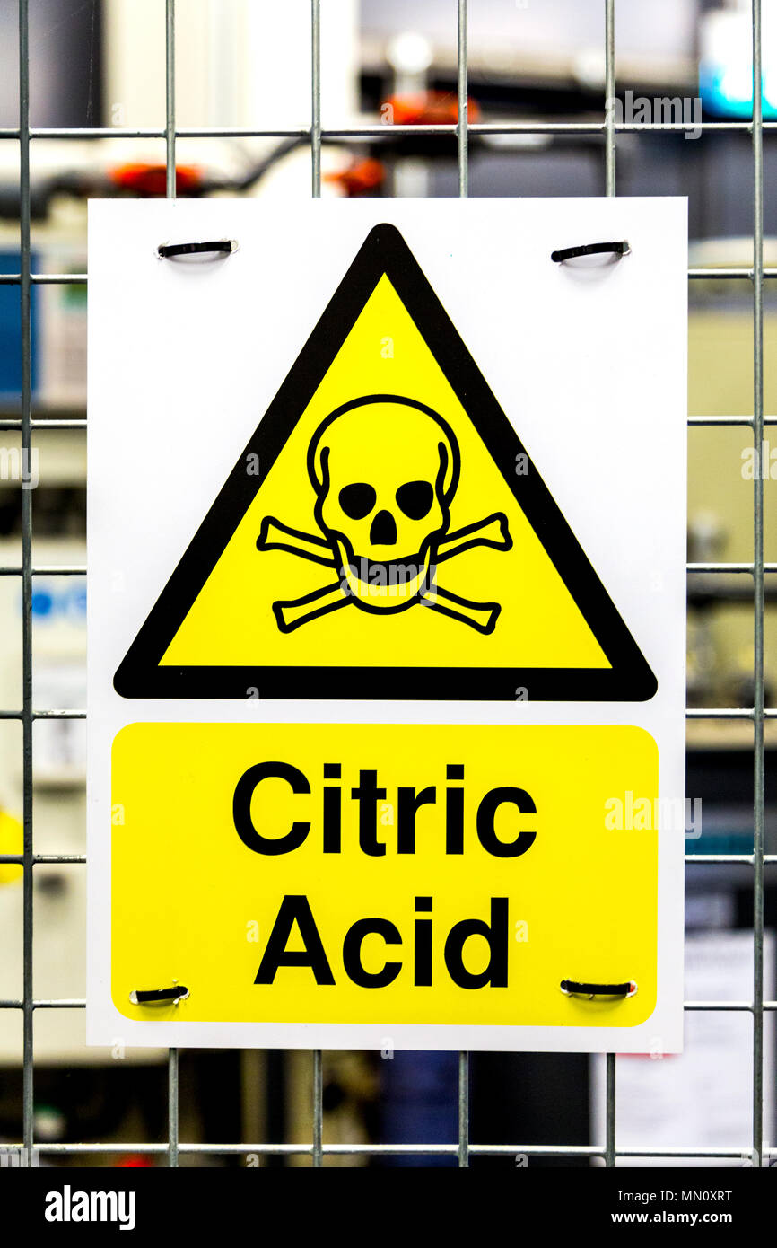 Toxic hazard danger yellow triangle sign with a skull for citric acid Stock Photo