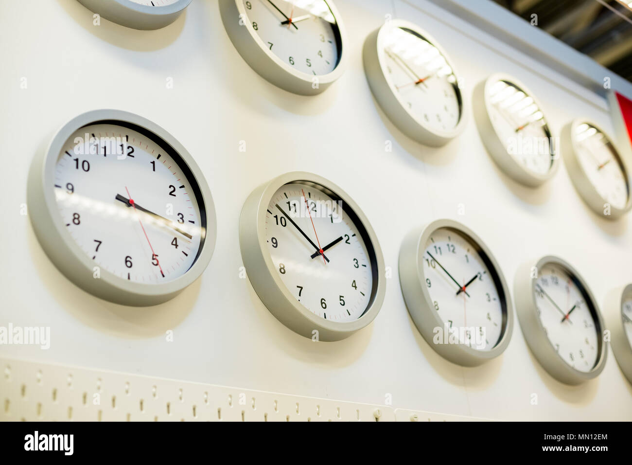 Many different wall clock on the wall. Clock time concept