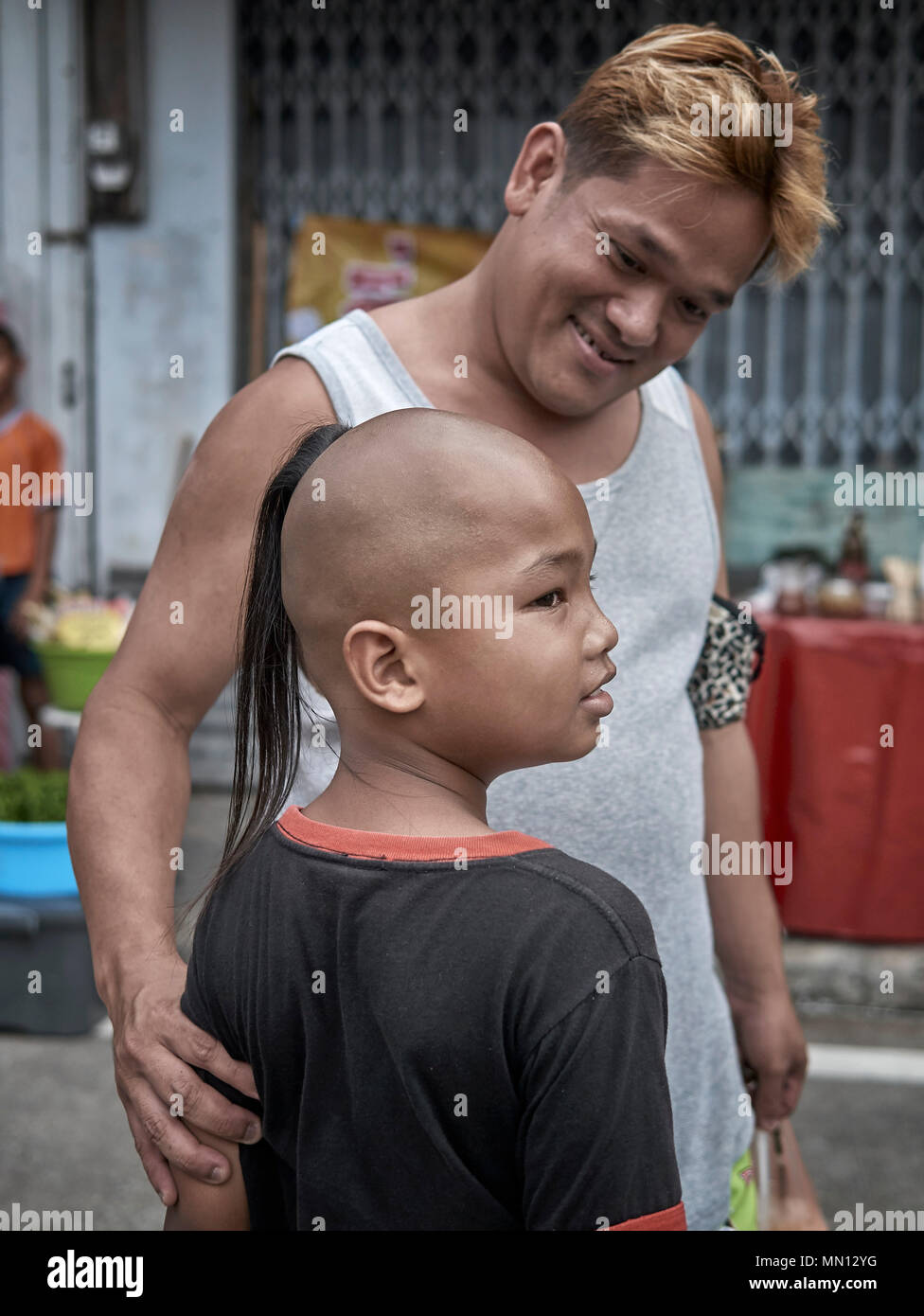 Traditional Top Knot Shaven Head Hairstyle On A Thai Young Boy