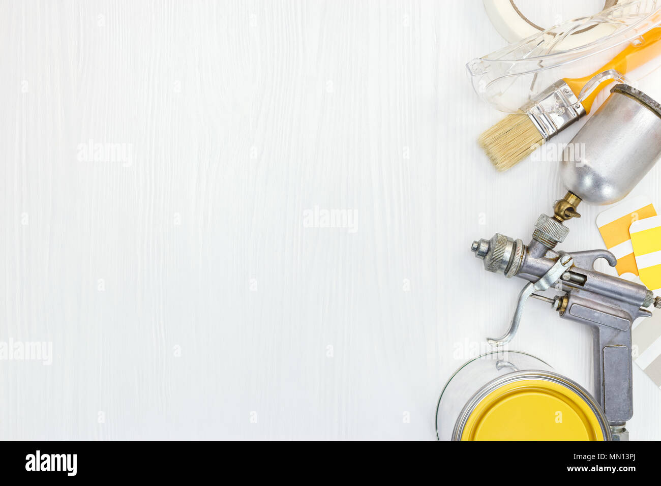 painting tools on white wooden background. painting airbrush, safety