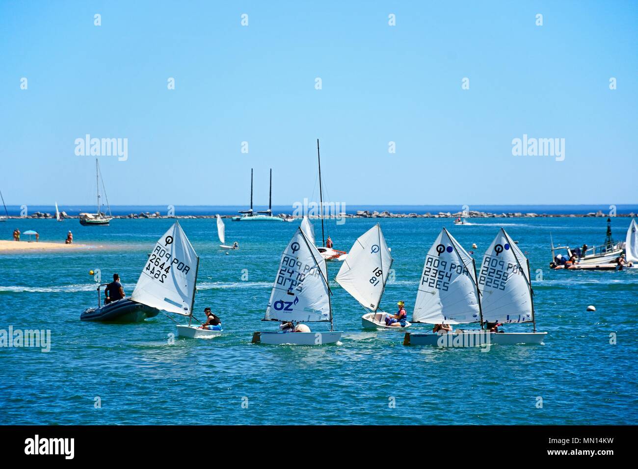 People sailing in Optimist dinghy boats on the river Arade, Ferragudo, Algarve, Portugal, Europe. Stock Photo