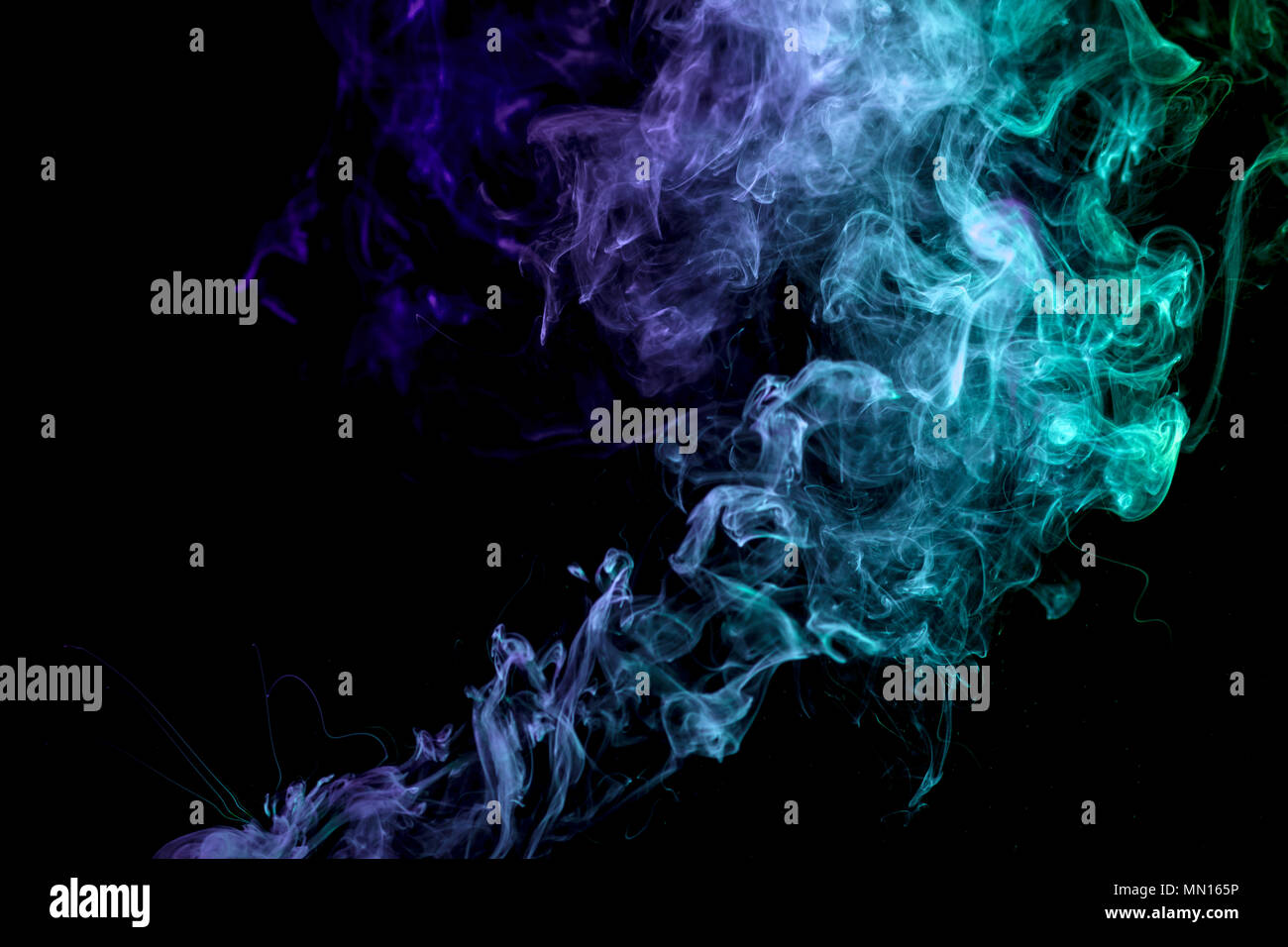 Colorful blue and green smoke on a black isolated background ...