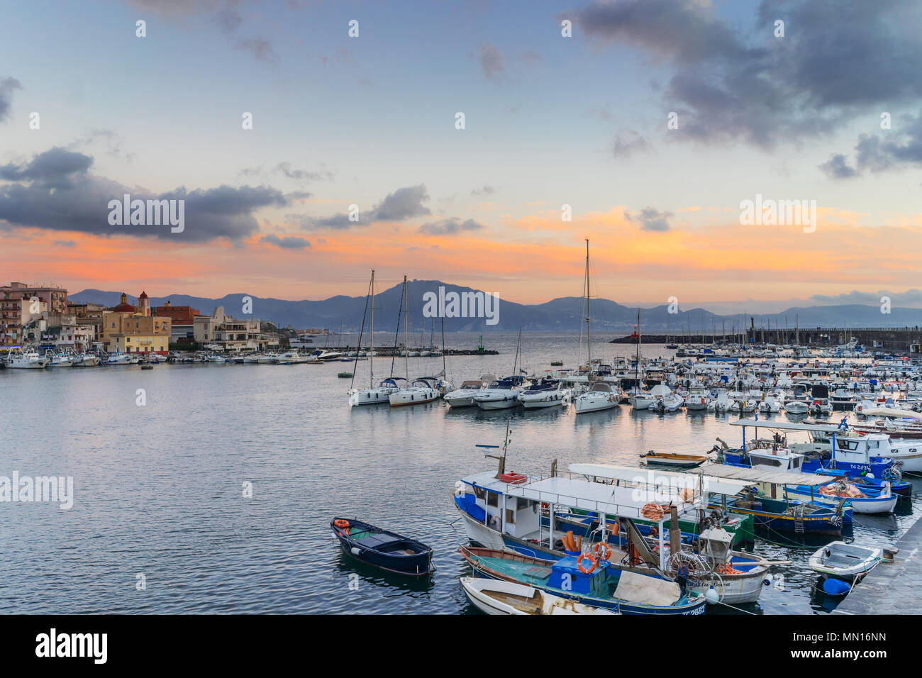 Sunset in Torre del Greco port near Naples, on background Sorrento peninsula, Campania, Italy Stock Photo