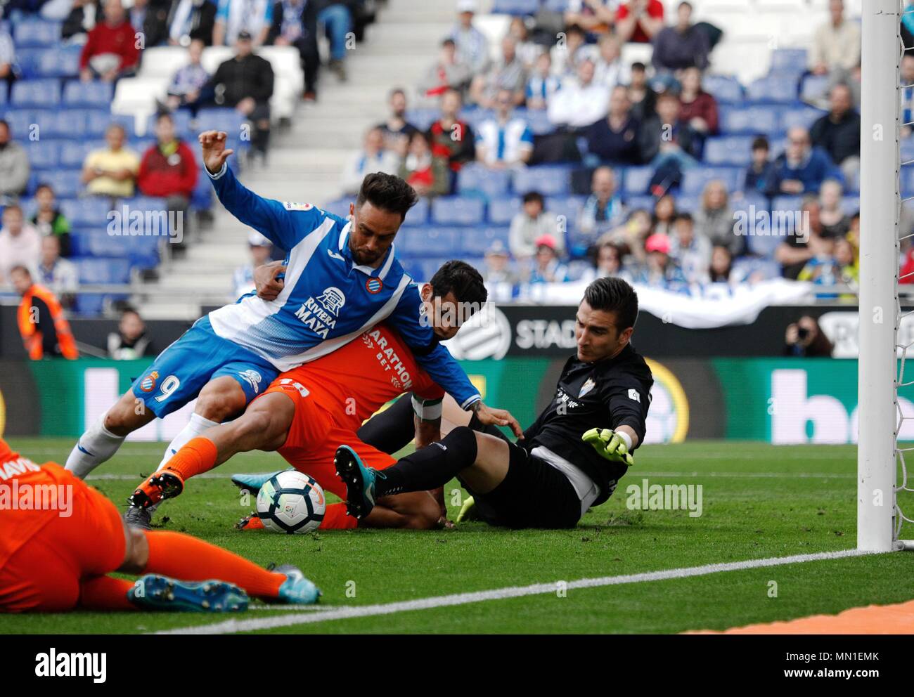 Barcelona, Spain. 13th May, 2018. RCD Espanyol's Sergio Garcia (L) scores during a Spanish league match between RCD Espanyol and Malaga in Barcelona, Spain, on May 13, 2018. RCD Espanyol won 4-1. Credit: Joan Gosa/Xinhua/Alamy Live News Stock Photo