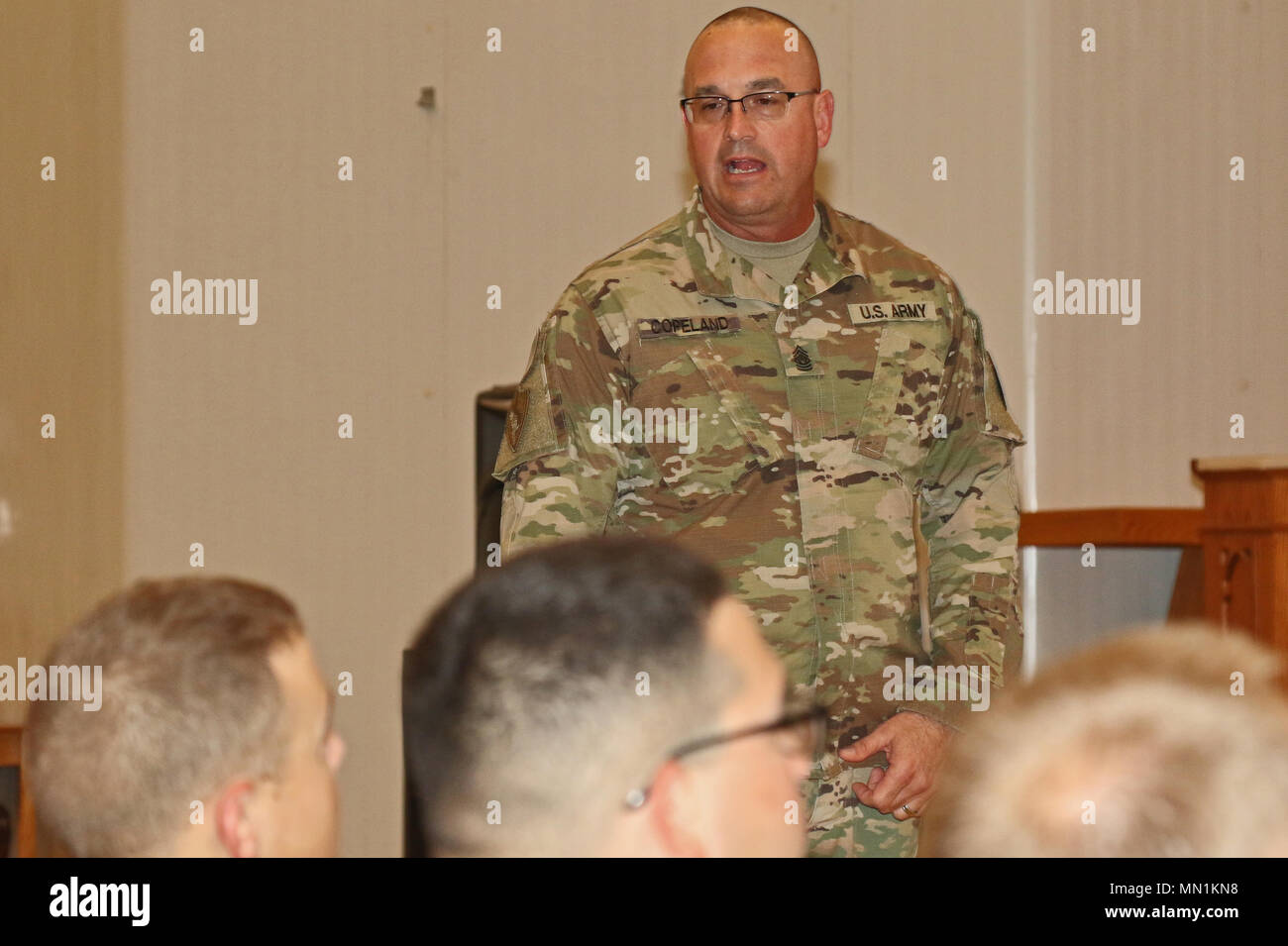 U.S. Army Command Sgt. Maj. Ted Copeland, U.S. Army Reserve command sergeant major, answers questions from Army Reserve Soldiers during a town hall meeting, Aug. 3, at Camp Arifjan, Kuwait. The Joint Monthly Access for Reserve Components enables leaders to observe first-hand the contributions of their personnel deployed in support of multiple named operations. Stock Photo