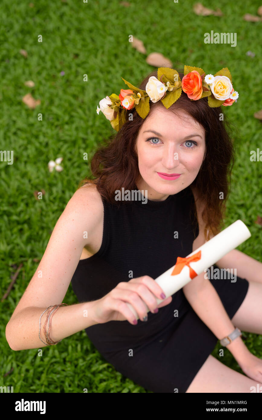 Young beautiful woman celebrating graduation at the park in Bang Stock Photo