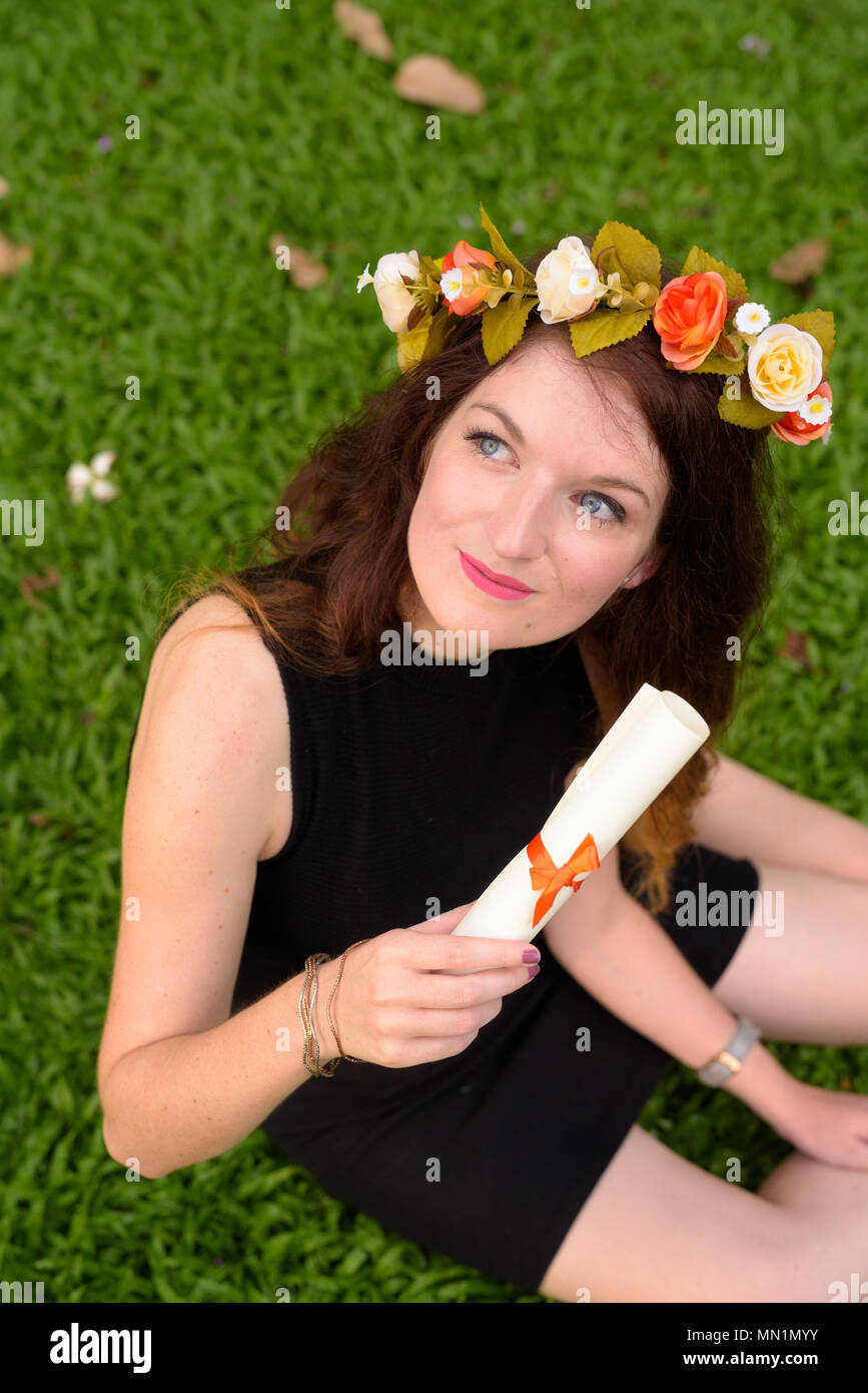 Young beautiful woman celebrating graduation at the park in Bang Stock Photo