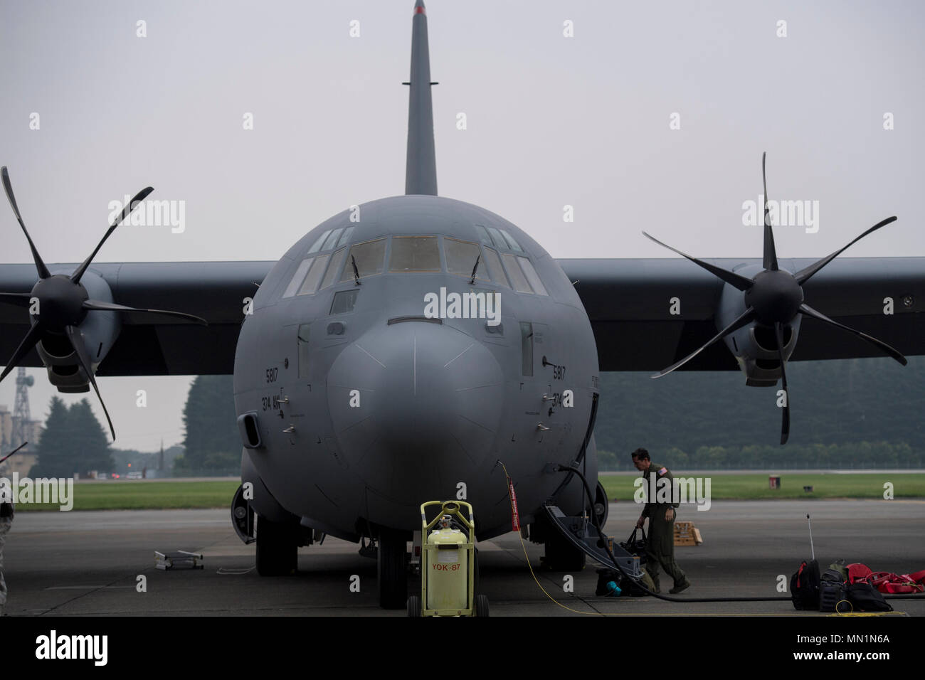 Crew member from the 36th Airlift Squadron unloads luggage from a C-130J Super Hercules at Yokota Air Base, Japan, Aug. 10, 2017. This is the fourth C-130J delivered to Yokota AB from Lockheed Martin facility. The new C-130J is 81% quieter during takeoff, 14% faster, can travel 1,287 km further, and can carry 4,090 kg more than its predecessor, the C-130H Hercules. (U.S. Air Force photo by Yasuo Osakabe) Stock Photo