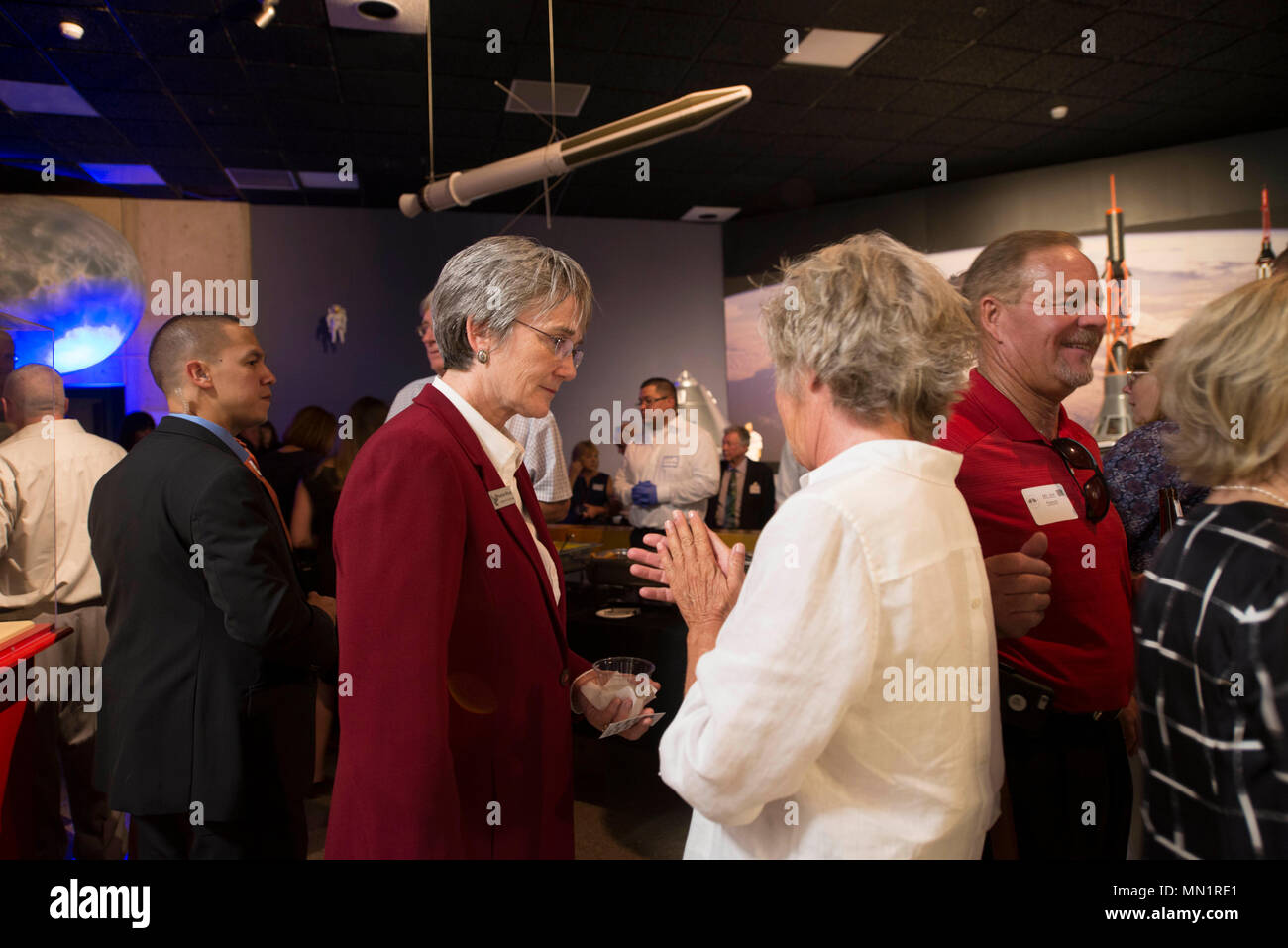 Secretary of the Air Force Heather Wilson speaks with a member of MainGate United, at the New Mexico Museum of Space history in Alamogordo, N.M., Aug. 8, 2017. Wilson came to Holloman Air Force Base and is here for a live-fly experiment with off-the-shelf aircraft. The Air Force is pursuing a Light Attack Capabilities Experimentation Campaign, which has grown out of our Close Air Support Experimentation Campaign. The Campaign is being led by the Air Force Strategic Development Planning and Experimentation Office under Air Force Materiel Command. (U.S. Air Force photo by Tech. Sgt. Amanda Junk) Stock Photo