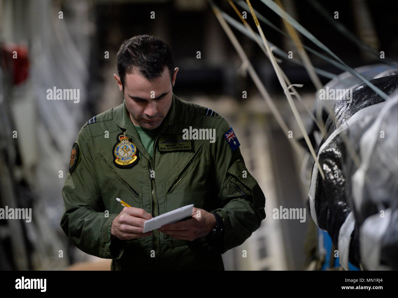 Royal Australian Air Force Flight Lt. Matthew Day, pilot with the 36th Squadron RAAF, checks