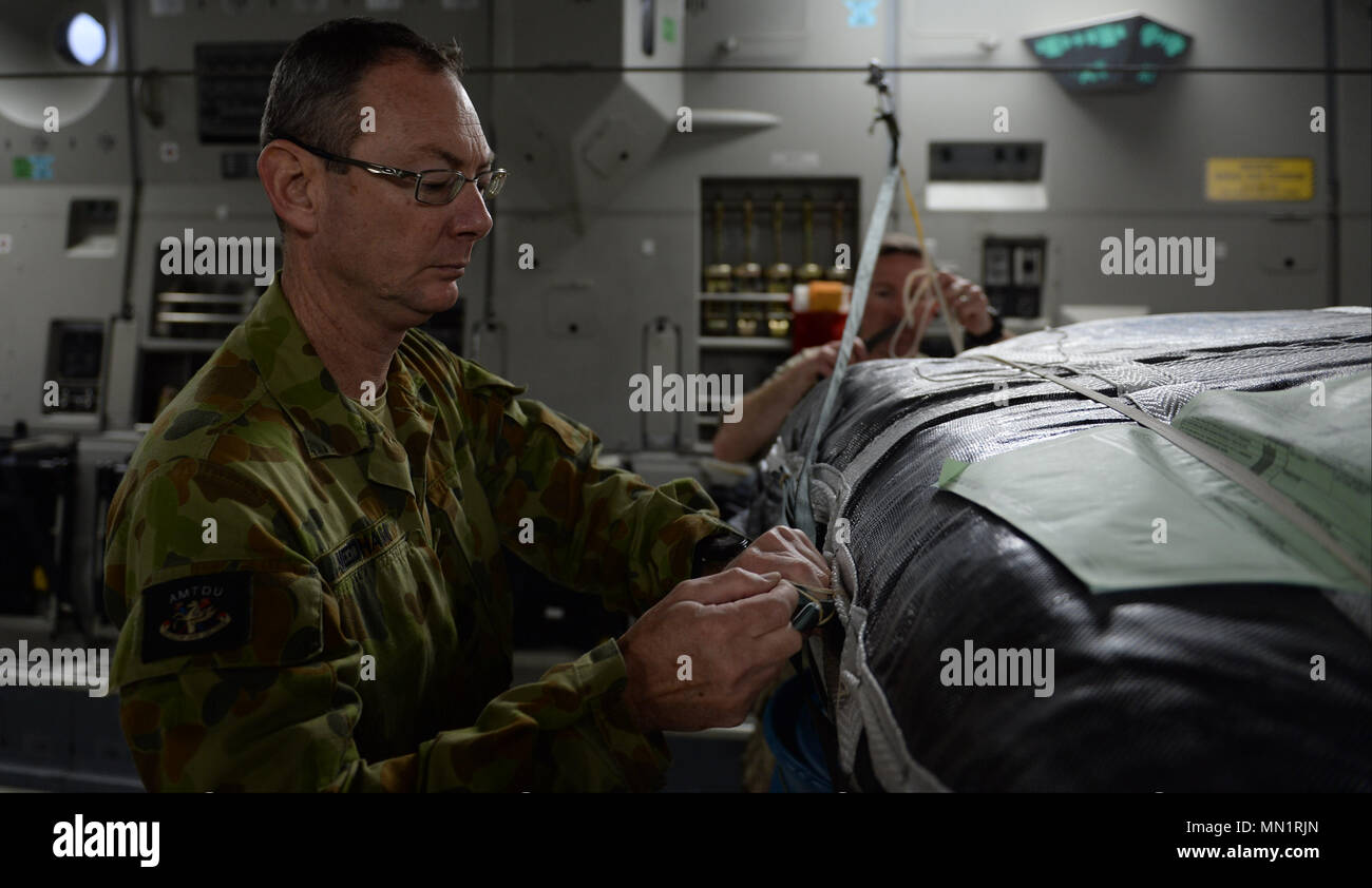 Royal Australian Army WO1 Sean Needham, project officer, Air Mobility  Training Development Unit, rigs cargo for air drop operations on a Royal  Australian Air Force C-17 Globemaster III during Exercise Mobility Guardian