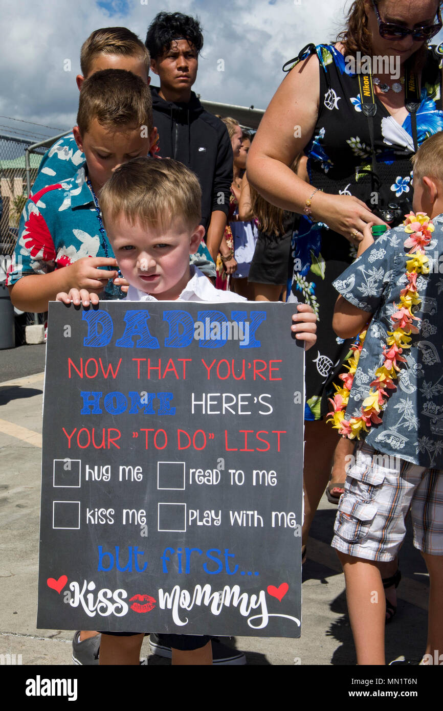 170810-N-YW024-0064 PEARL HARBOR Michael Fedderly holds a sign during the final homecoming arrival of a Los Angeles-class attack submarine USS Jacksonville (SSN 699) at Joint Base Pearl Harbor-Hickam, Aug. 10. USS Jacksonville was commissioned on May 16, 1981 and was recently deployed to the U.S. 5th Fleet area of operations and Indian Ocean. The submarine's ability to support a multitude of missions, including anti-submarine warfare, anti-surface ship warfare, strike warfare, surveillance and reconnaissance, has made USS Jacksonville one of the most capable submarines in the world. The submar Stock Photo