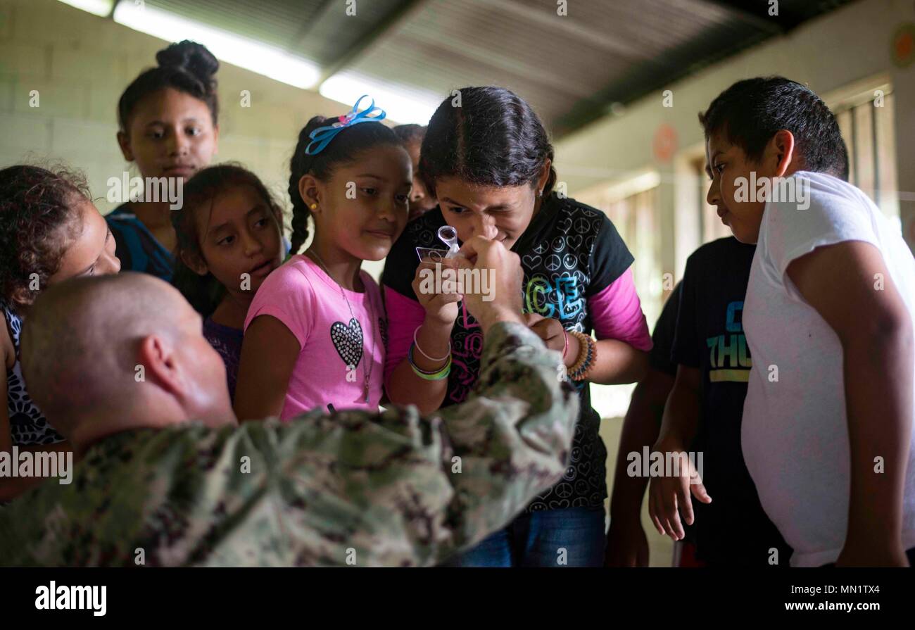 170810-N-KW679-0056 Tarros, Honduras (August 10, 2017) Lt. Cmdr. Ian Sutherland, technical director assigned to the Navy Entomology Center of Excellence, teaches students about entomology, during a Southern Partnership Station 17 community relations project (COMREL) at Escuela Rural Mixta Luz y Esperanza, a local elementary school. SPS 17 is a U.S. Navy deployment, executed by U.S. Naval Forces Southern Command/U.S. 4th Fleet, focused on subject matter expert exchanges with partner nation militaries and security forces in Central and South America. (U.S. Navy photo by Mass Communication Specia Stock Photo
