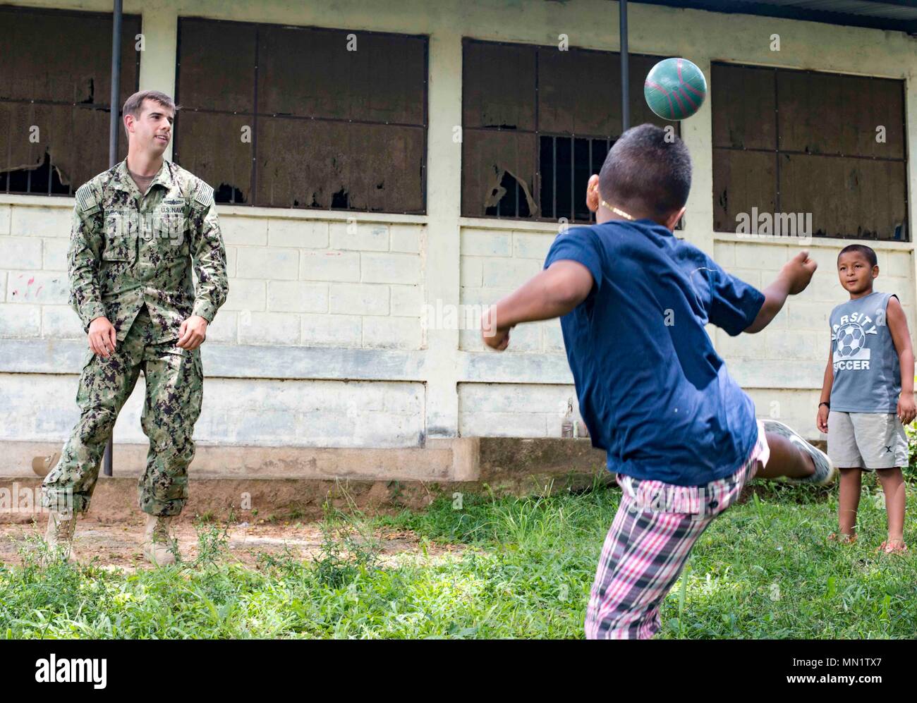 170810-N-KW679-0144 Tarros, Honduras (August 10, 2017) Lt. j.g. Jack Dembowski, assistant operations officer for Southern Partnership Station 17, plays soccer with Honduran students, during a community relations project (COMREL) at Escuela Rural Mixta Luz y Esperanza, a local elementary school. SPS 17 is a U.S. Navy deployment, executed by U.S. Naval Forces Southern Command/U.S. 4th Fleet, focused on subject matter expert exchanges with partner nation militaries and security forces in Central and South America. (U.S. Navy photo by Mass Communication Specialist 3rd Class Kristen Cheyenne Yarber Stock Photo
