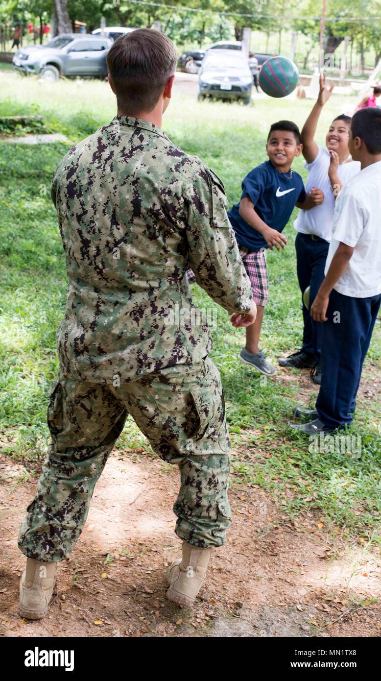 170810-N-KW679-0149 Tarros, Honduras (August 10, 2017) Lt. j.g. Jack Dembowski, assistant operations officer for Southern Partnership Station 17, plays soccer with Honduran students, during a community relations project (COMREL) at Escuela Rural Mixta Luz y Esperanza, a local elementary school. SPS 17 is a U.S. Navy deployment, executed by U.S. Naval Forces Southern Command/U.S. 4th Fleet, focused on subject matter expert exchanges with partner nation militaries and security forces in Central and South America. (U.S. Navy photo by Mass Communication Specialist 3rd Class Kristen Cheyenne Yarber Stock Photo