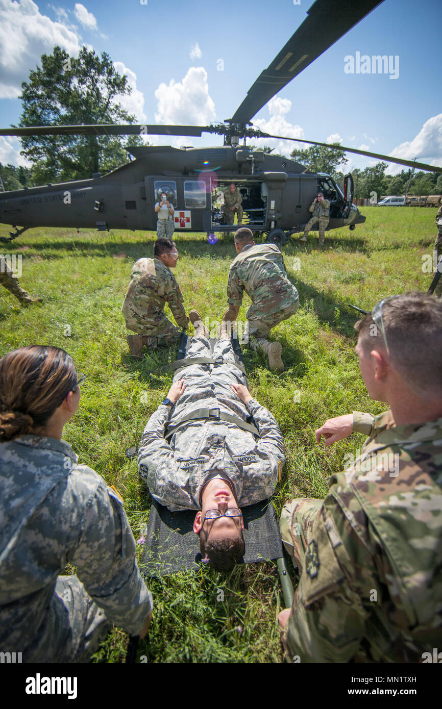 U.S. Army Reserve Soldiers from the 328th Combat Support Hospital (CSH) and 349th CSH practice hot-load litter techniques during Combat Support Training Exercise (CSTX) 86-17-02 at Fort McCoy, Wis., August 10, 2017. Hot-load litter techniques involve actual simulated casualties being carried on the litter. CSTX includes more than 12,000 service members from the Army, Navy, Air Force and Marine Corps as well as from six countries. CSTX is a large-scale training event where units experience tactical training scenarios specifically designed to replicate real-world missions. (U.S. Army Reserve pho Stock Photo
