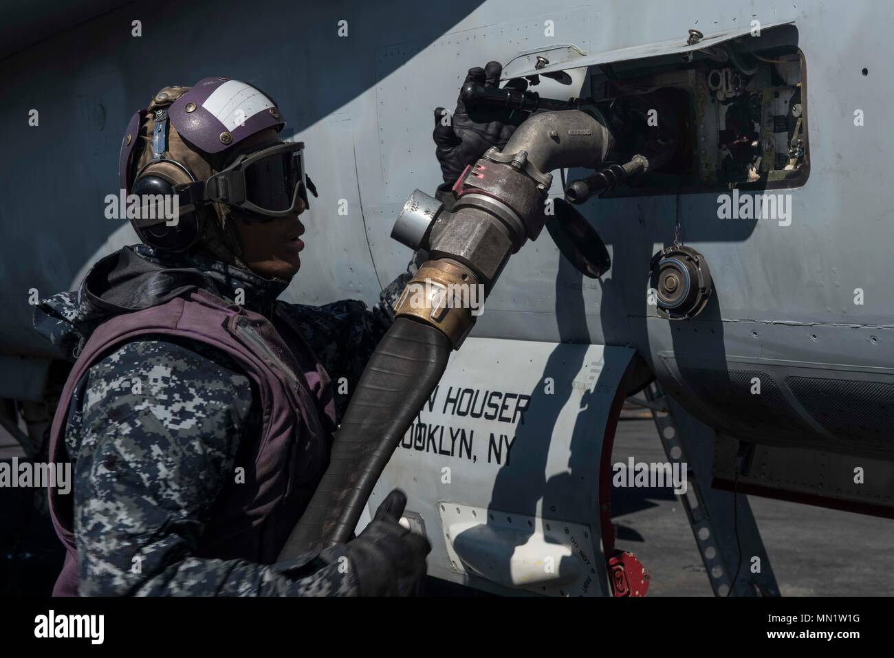 170808-N-AJ467-200 ATLANTIC OCEAN (Aug. 8, 2017) Aviation Boatswain’s Mate (Fuels) Airman Dean Cox refuels an aircraft after flight operations on the flight deck of the Nimitz-class aircraft carrier USS George H.W. Bush (CVN 77) during exercise Saxon Warrior 2017, Aug. 8. Saxon Warrior is a United States and United Kingdom co-hosted carrier strike group exercise that demonstrates interoperability and capability to respond to crises and deter potential threats. (U.S. Navy photo by Mass Communication Specialist Seaman Darien Weigel/Released) Stock Photo