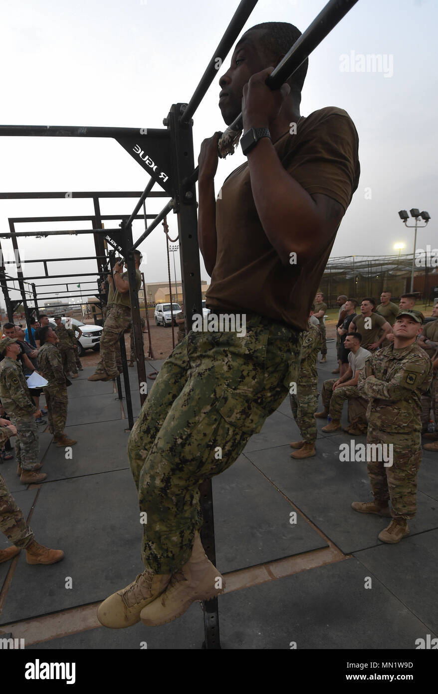 A U.S. service member completes a flexed arm hang during a physical