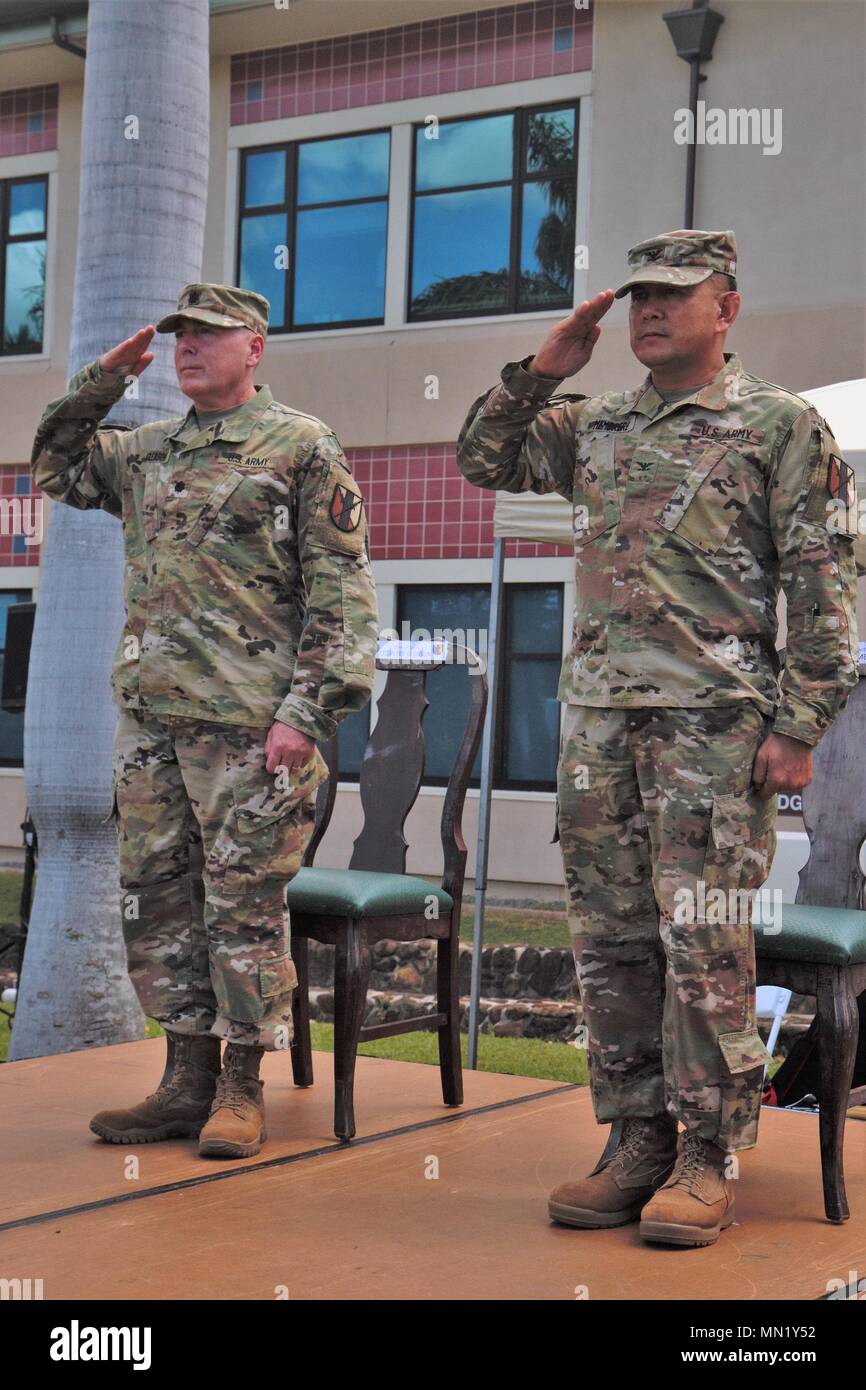 Lt. Col. Peter Gleason (left), commander of the 63rd Brigade Support Battalion, and Col. Samuel Membrere, commander of the 303rd Maneuver Enhancement Brigade, render salute during an inactivation at Fort Shafter Flats, Honolulu, Aug. 06, 2017. The inactivation ceremony marked the official inactivation of the 63rd BSB. Stock Photo