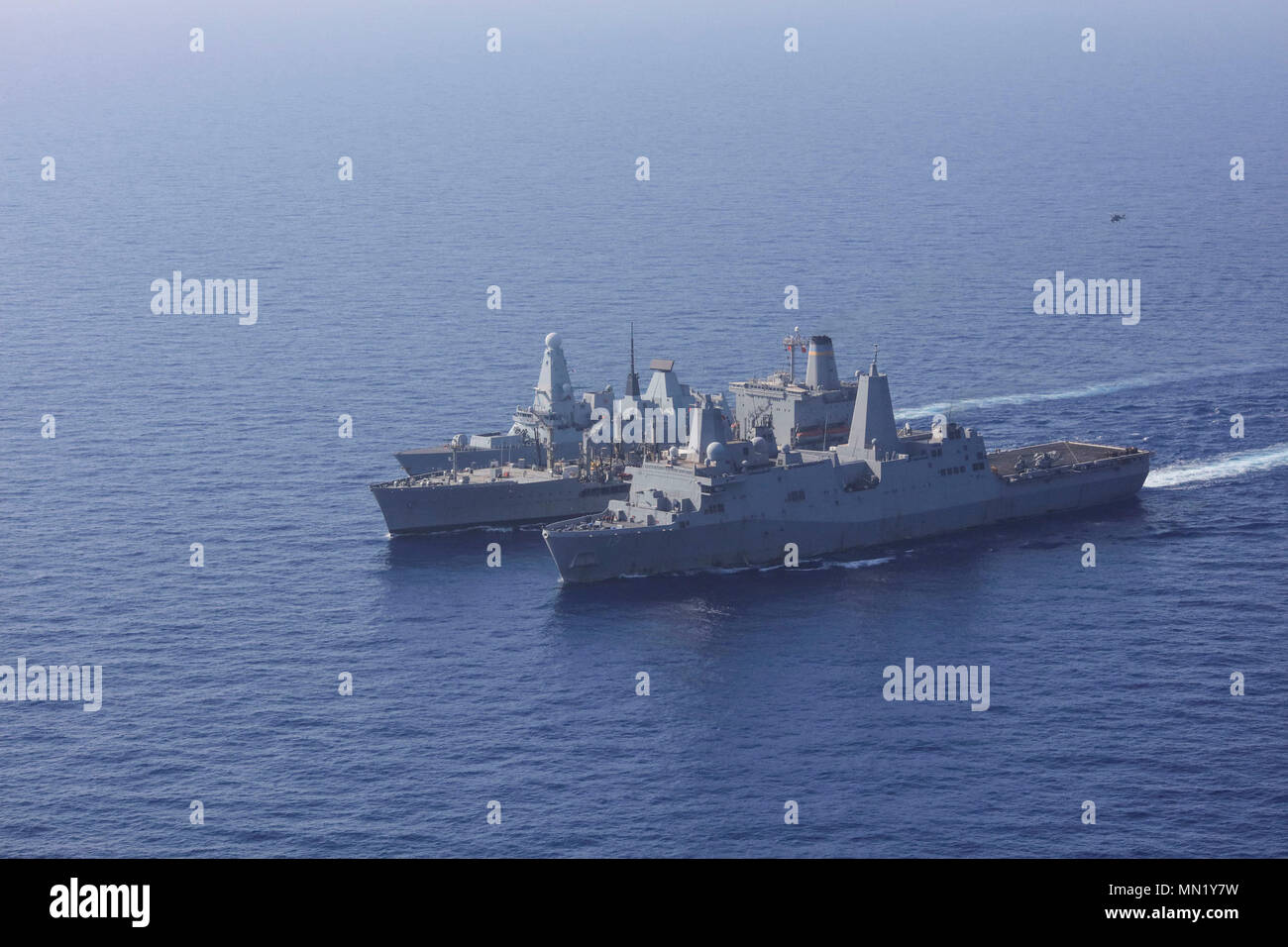 170811-N-FM530-145  MEDITERRANEAN SEA (Aug. 11, 2017) The British destroyer HMS Duncan (D37), left, the fleet replenishment oiler USNS Patuxent (T-AO 201), middle, and the San Antonio-class amphibious transport dock ship USS Mesa Verde (LPD 19) sail in formation during a replenishment-at-sea Aug. 11, 2017. Mesa Verde is deployed with the Bataan Amphibious Ready Group and 24th Marine Expeditionary Unit to support maritime security operations and theater security cooperation efforts in the U.S. 6th Fleet and U.S. 5th Fleet areas of operations. (U.S. Navy photo by Mass Communication Specialist 2n Stock Photo