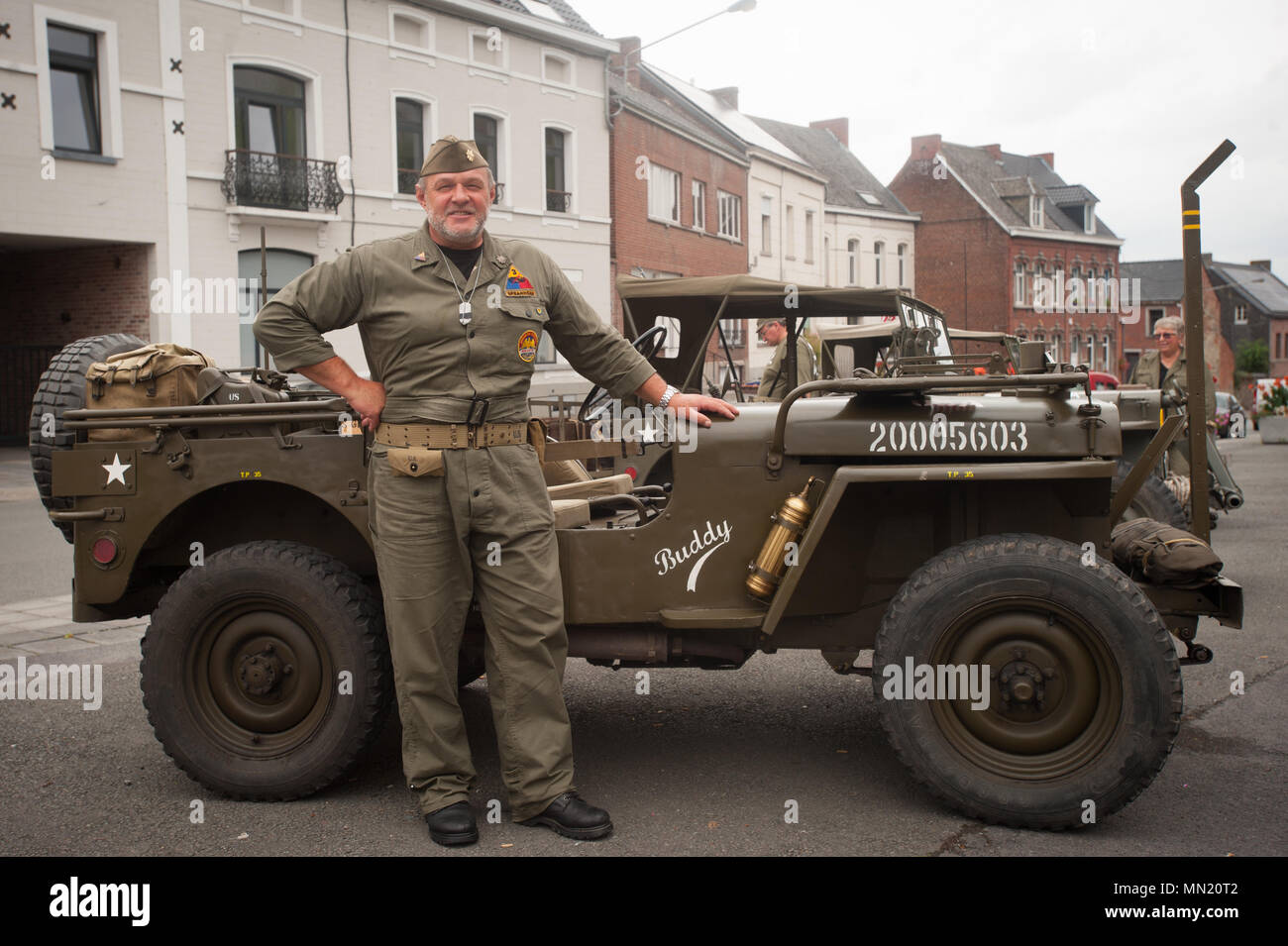 A reenactor poses with a historical vehicle during the memorial ceremony for Belgian Lt. Col. Joseph Daumerie, Aug. 15, 2017, Brugelette, Belgium. The memorial commemorates the 75th anniversary of Daumerie's death. Daumerie is a war hero and fighter pilot who was executed in 1942 during World War II. The event offered a unique opportunity for the U.S. service members to honor a fallen hero and strengthen their relationship with NATO allies during the U.S. Army Garrison Benelux's 50th anniversary in Belgium. (U.S. Navy Photo by Information System Technician Seaman Daniel Gallegos/Released) Stock Photo