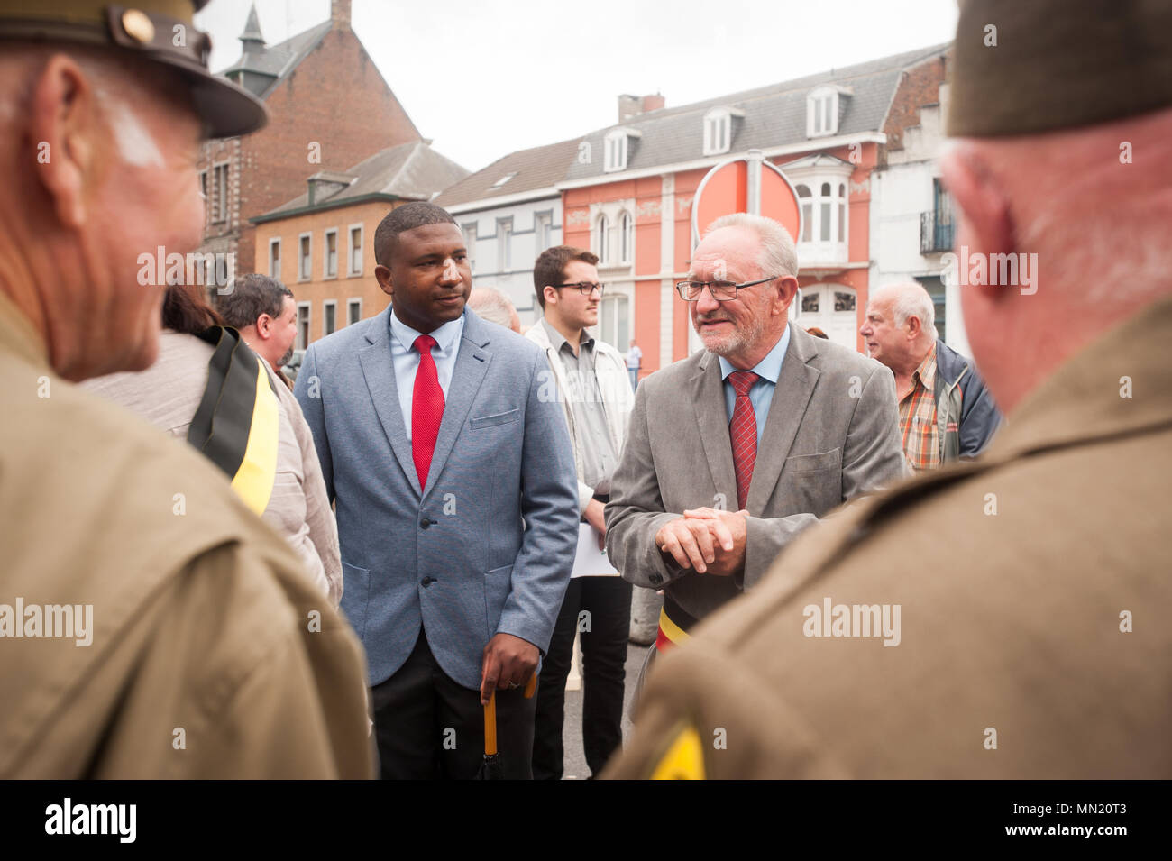 André Desmarlières, Mayor of Brugelette, Belgium speaks with attendees during the memorial ceremony for Belgian Lt. Col. Joseph Daumerie, Aug. 15, 2017, Brugelette, Belgium. The memorial commemorates the 75th anniversary of Daumerie's death. Daumerie is a war hero and fighter pilot who was executed in 1942 during World War II. The event offered a unique opportunity for the U.S. service members to honor a fallen hero and strengthen their relationship with NATO allies during the U.S. Army Garrison Benelux's 50th anniversary in Belgium. (U.S. Navy Photo by Information System Technician Seaman Dan Stock Photo
