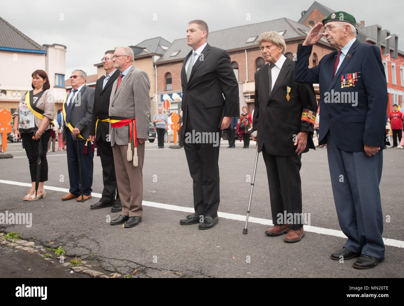 André Desmarlières, Mayor of Brugelette, Belgium, LTC Bill Lovell, Command Chaplain for USAG Benelux, and other participants show honors during the Belgian national anthem at a monument during the memorial ceremony for Belgian Lt. Col. Joseph Daumerie, Aug. 15, 2017, Brugelette, Belgium. The memorial commemorates the 75th anniversary of Daumerie's death. Daumerie is a war hero and fighter pilot who was executed in 1942 during World War II. The event offered a unique opportunity for the U.S. service members to honor a fallen hero and strengthen their relationship with NATO allies during the U.S Stock Photo