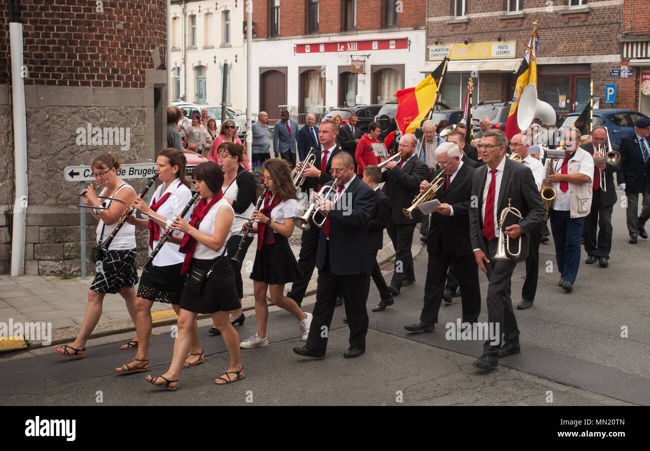 Musicians march while playing instruments during the memorial ceremony for Belgian Lt. Col. Joseph Daumerie, Aug. 15, 2017, Brugelette, Belgium. The memorial commemorates the 75th anniversary of Daumerie's death. Daumerie is a war hero and fighter pilot who was executed in 1942 during World War II. The event offered a unique opportunity for the U.S. service members to honor a fallen hero and strengthen their relationship with NATO allies during the U.S. Army Garrison Benelux's 50th anniversary in Belgium. (U.S. Navy Photo by Information System Technician Seaman Daniel Gallegos/Released) Stock Photo