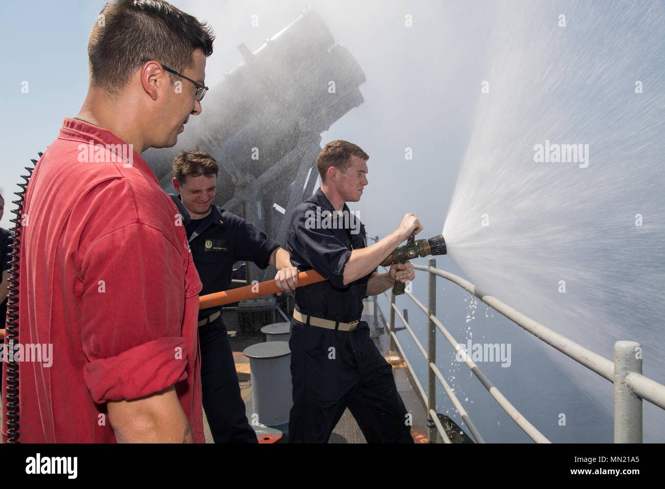 N Vr594 0153 Arabian Gulf August 8 17 Damage Controlman 1st Class Landon Menard From Sault Ste Marie Mich Gives Midshipmen On Firehose Training Aboard The Ticonderoga Class Guided Missile Cruiser Uss Princeton Cg 59 Princeton