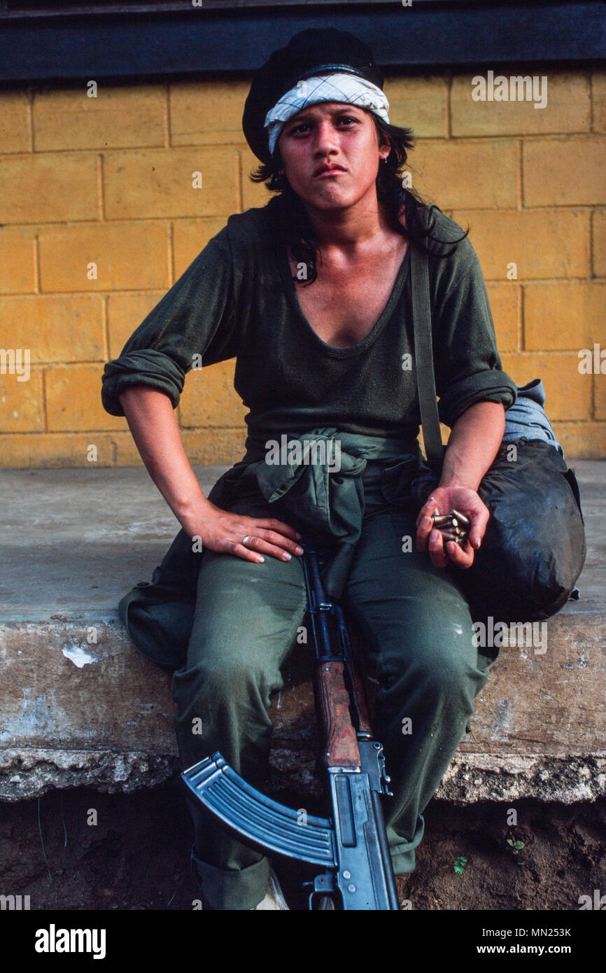 Managua, Nicaragua, June 1986; As a training exercise the Sandinista FSLN army sets up a mock US invasion of Managua. A young participant with her AK47. Stock Photo