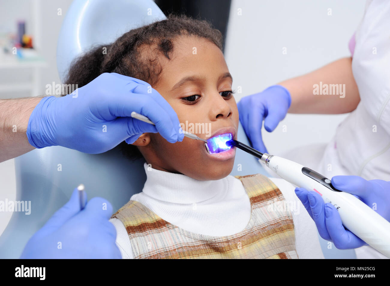 a dark-skinned baby girl in the dentist's chair Stock Photo