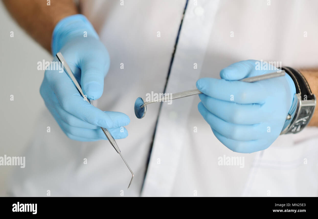 dental instruments in the hands of doctor Stock Photo Alamy