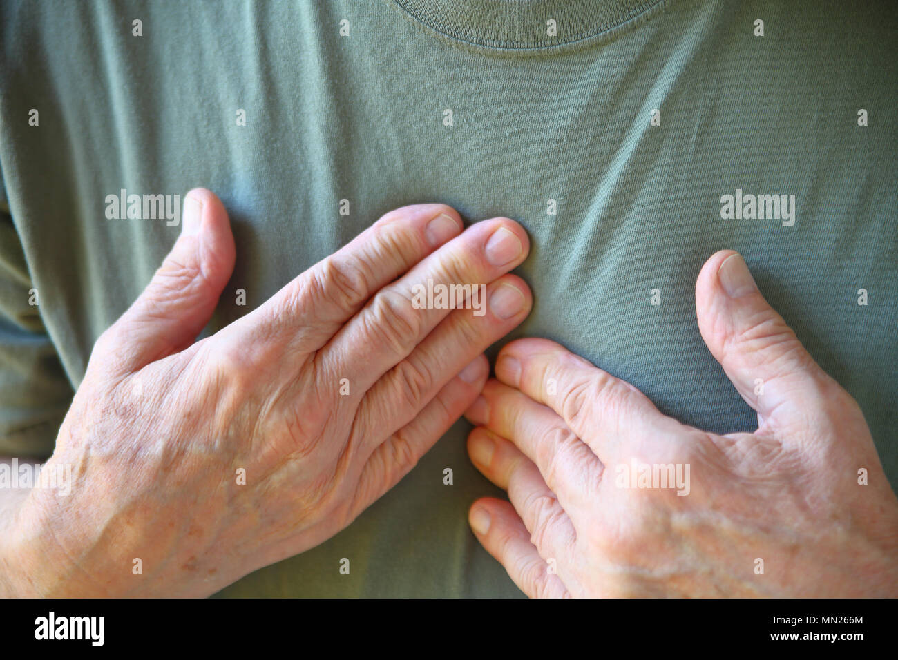 Senior man feels cardiac pain closeup Stock Photo